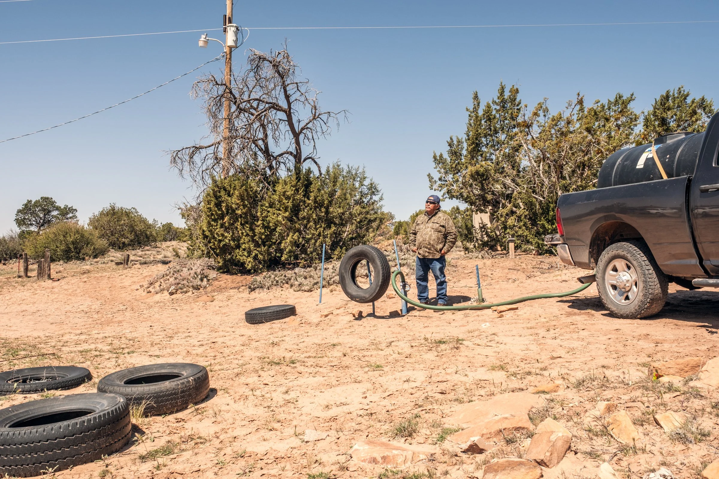 Hauling Life | Navajo Nation — Unified Metadata Paragraphs

Wayne Wilson and Joann Whiting collect water in Gallup, New Mexico at a community water source. The containers are filled, prepared, and loaded into their vehicle for transport across the Na
