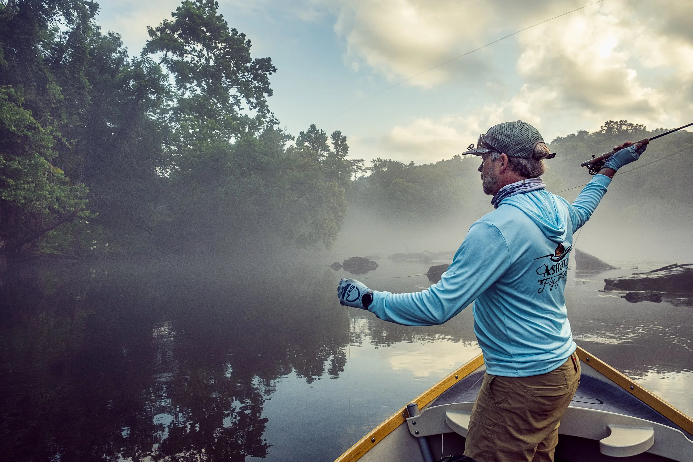 Guided fly fishing trip with Asheville Fly Fishing Company on a foggy river near Asheville, North Carolina. Photographed by Lange Photo Studio.
