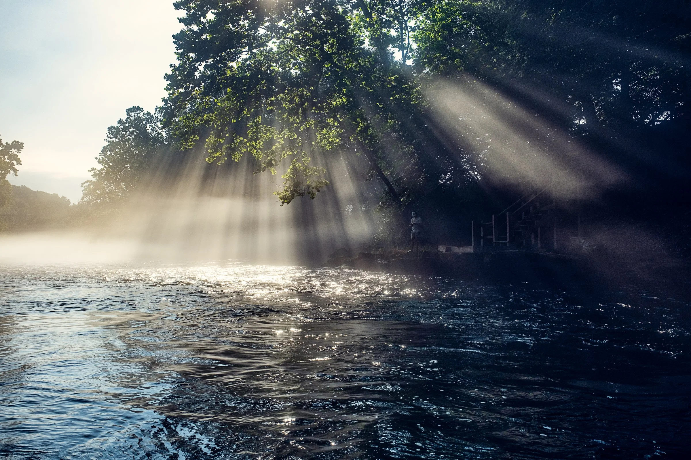 Guided fly fishing trip with Asheville Fly Fishing Company on a foggy river near Asheville, North Carolina. Photographed by Lange Photo Studio.