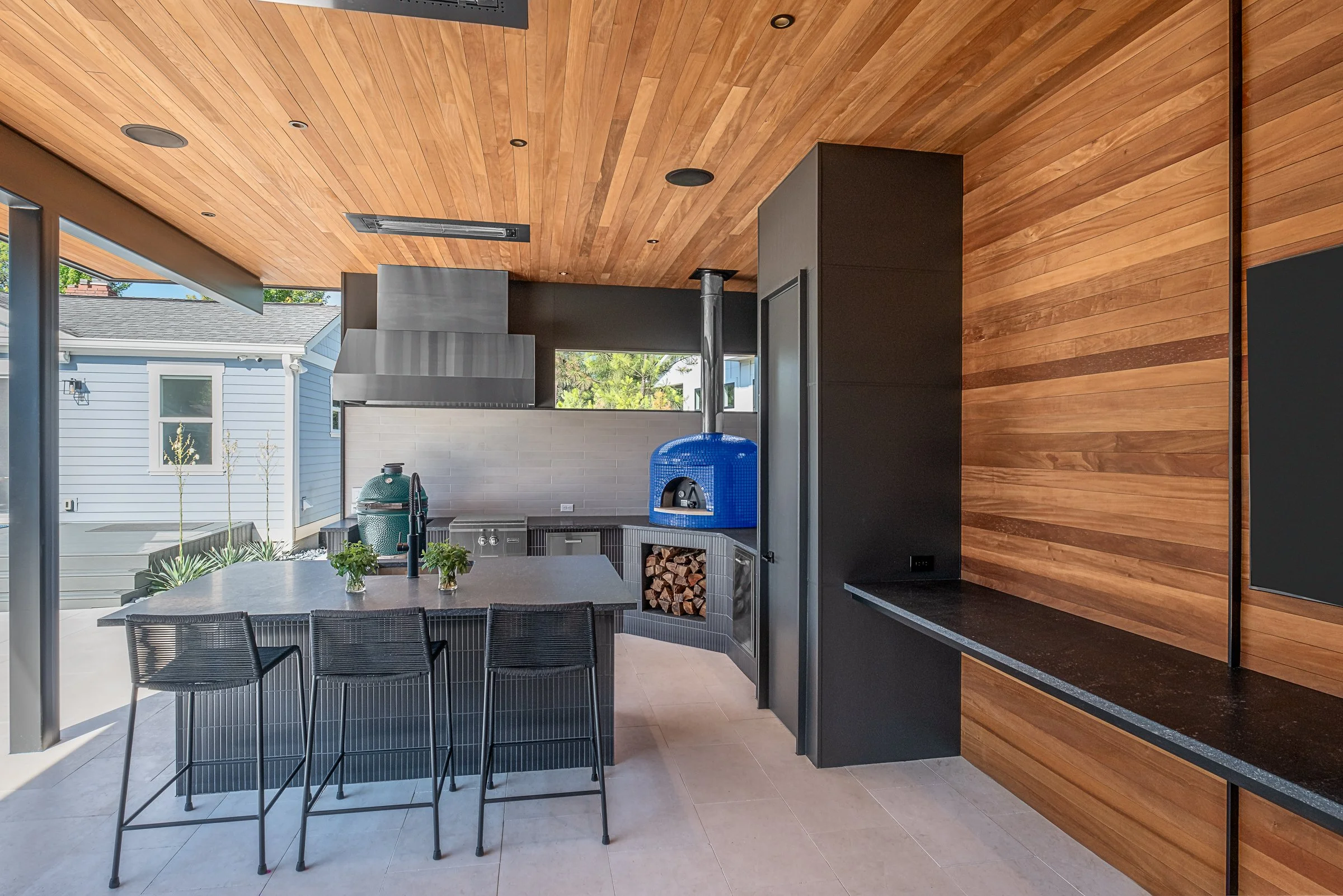 Modern pool pavilion architecture featuring clean lines, natural materials, and seamless indoor-outdoor living spaces in Charlotte, North Carolina. This contemporary structure showcases floor-to-ceiling glass walls, exposed wooden beams, and a minima