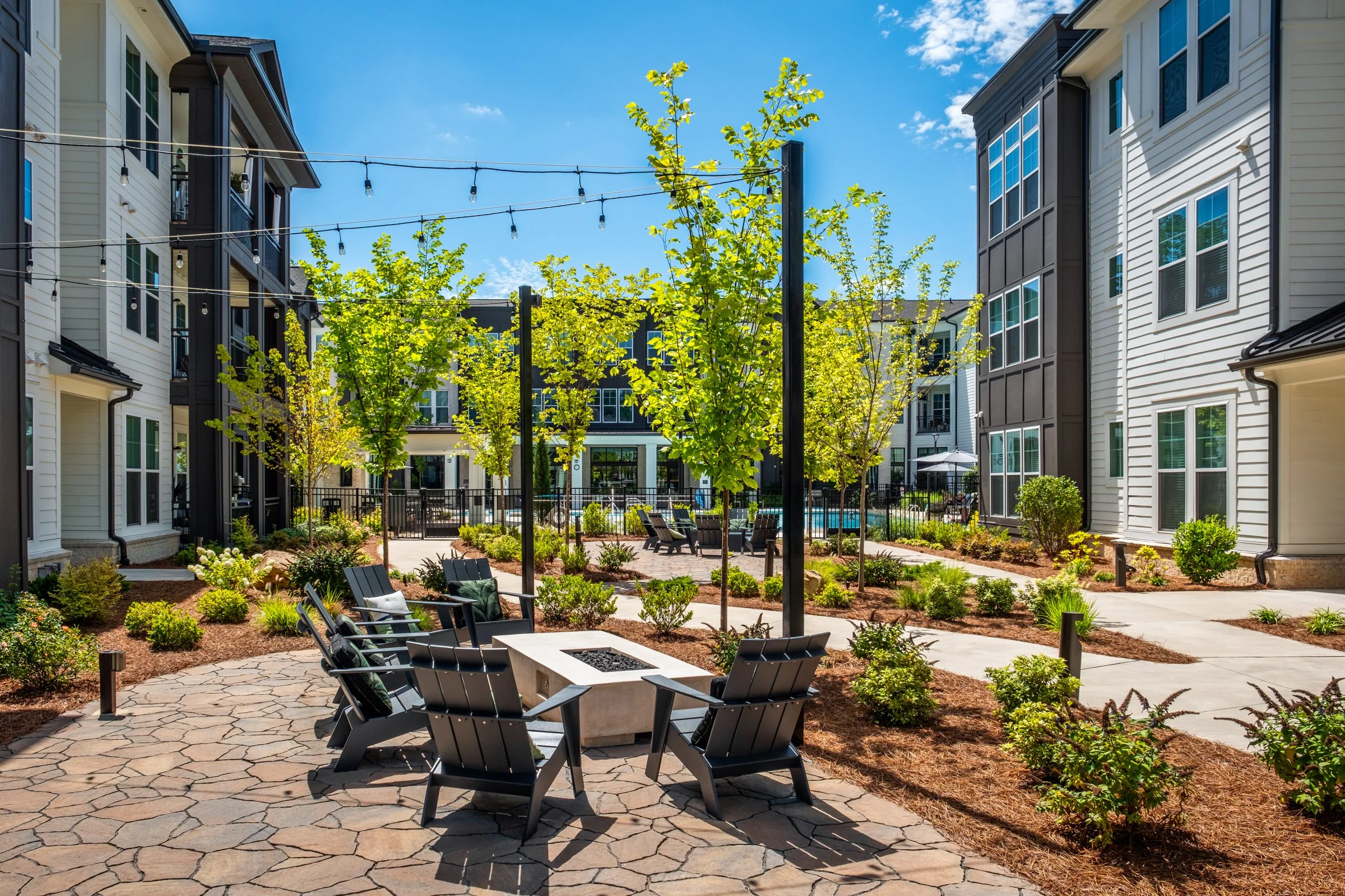 Connery on Providence 55+ community pool and adjacent amenity space, showcasing photography landscape design and seating areas, Charlotte, NC. Created by Lange Photo Studio. 