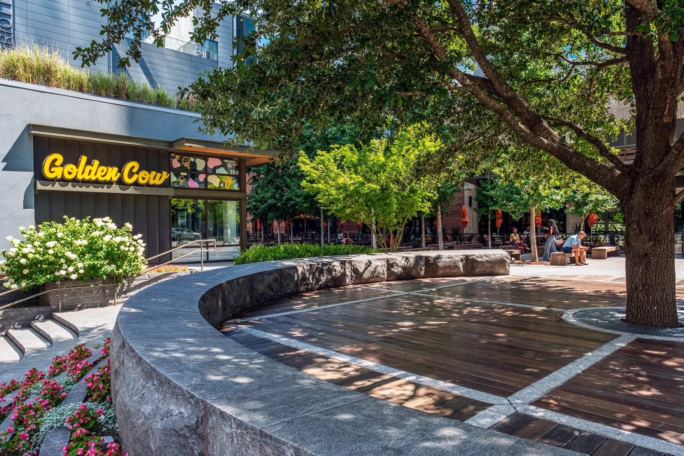 Daytime exterior view of Ally Charlotte Center, highlighting its modern architecture and urban setting in Uptown Charlotte.”