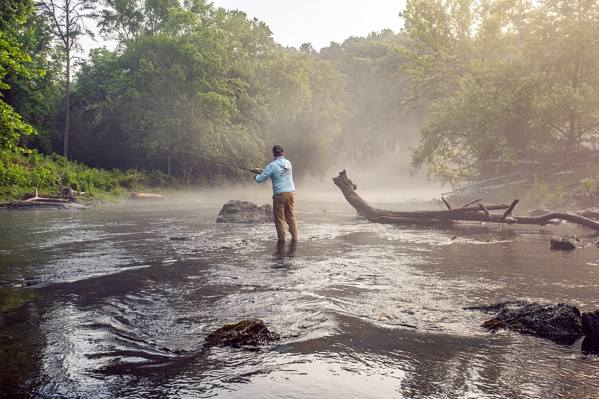Guided fly fishing trip with Asheville Fly Fishing Company on a foggy river near Asheville, North Carolina. Photographed by Lange Photo Studio.