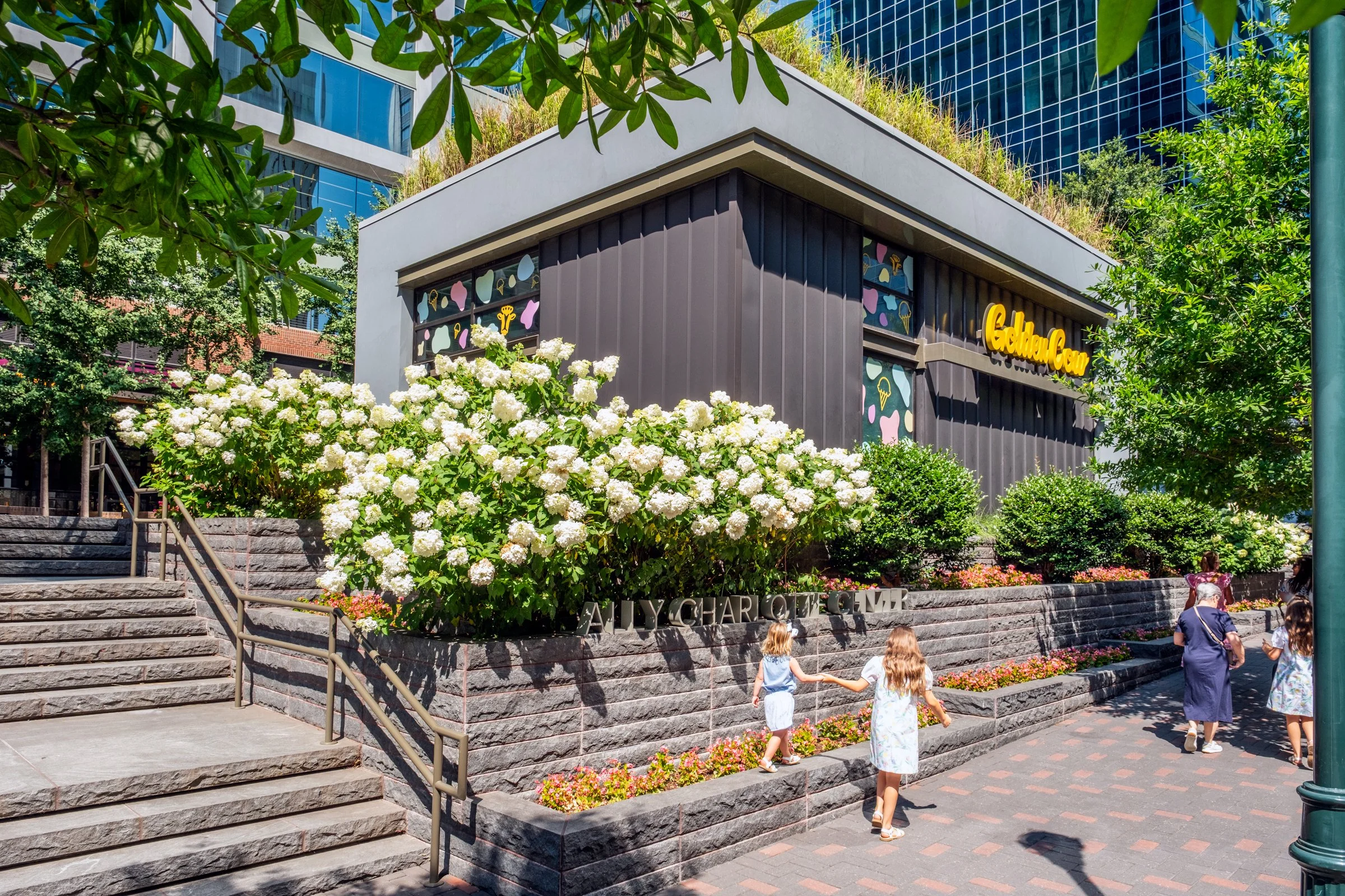 Daytime exterior view of Ally Charlotte Center, highlighting its modern architecture and urban setting in Uptown Charlotte.”
