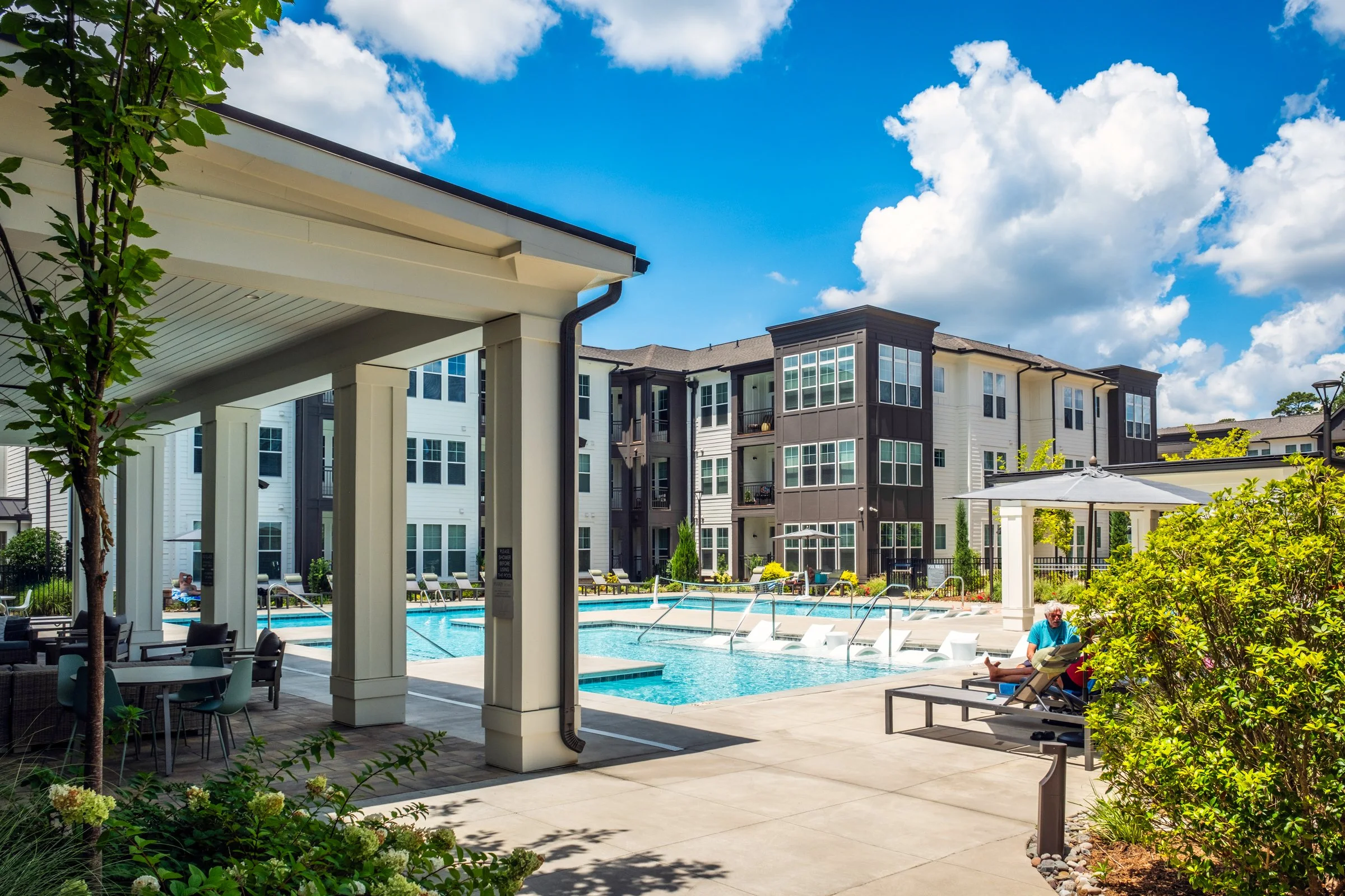 Connery on Providence 55+ community pool and adjacent amenity space, showcasing photography landscape design and seating areas, Charlotte, NC. Created by Lange Photo Studio. 