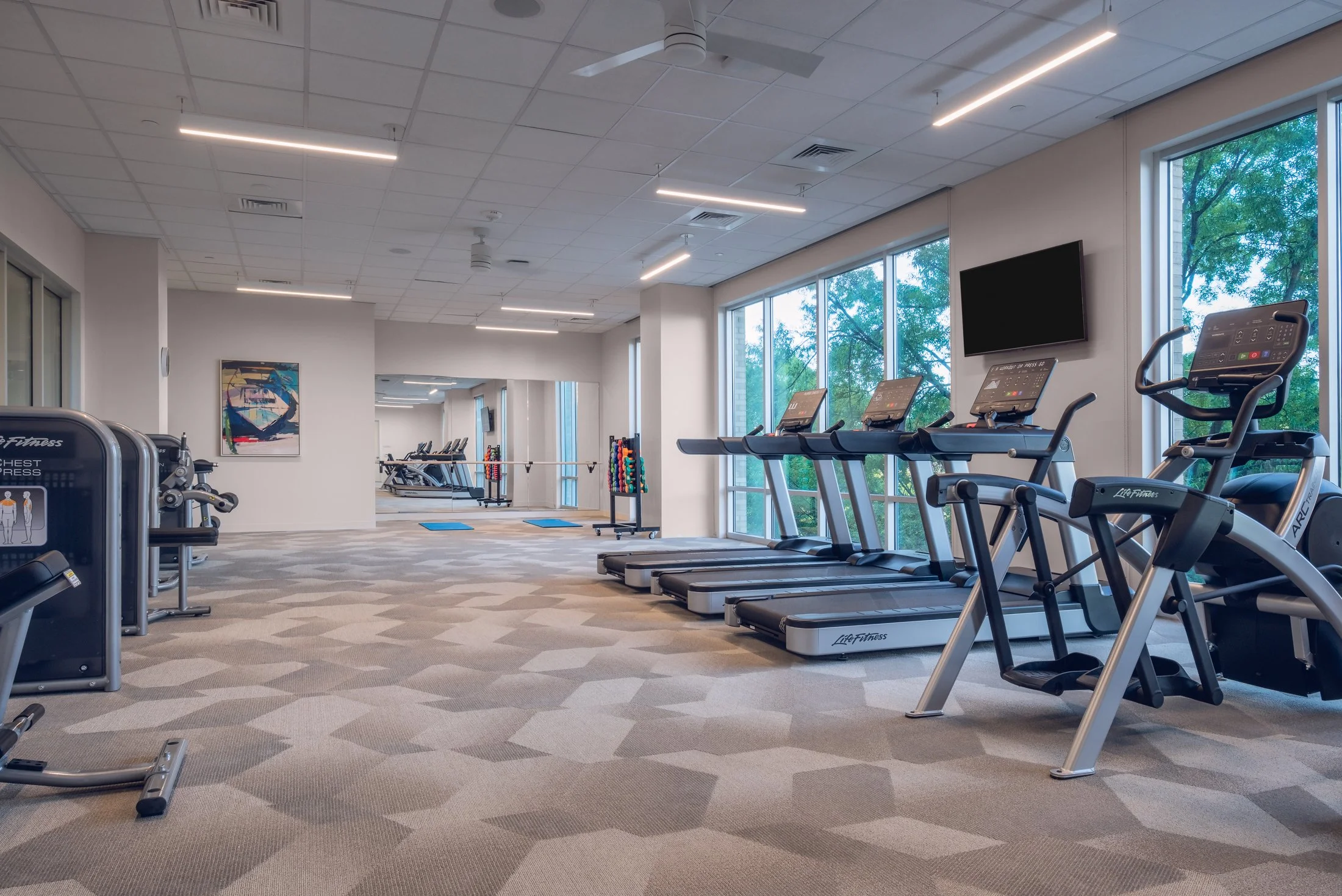 Community amenity space at Village on Morehead showing lounge area with modern furnishings and architectural lighting