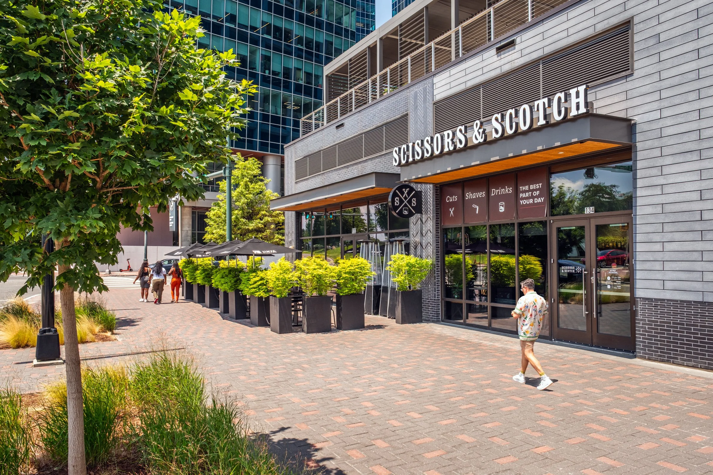 Daytime exterior view of Ally Charlotte Center, highlighting its modern architecture and urban setting in Uptown Charlotte.”