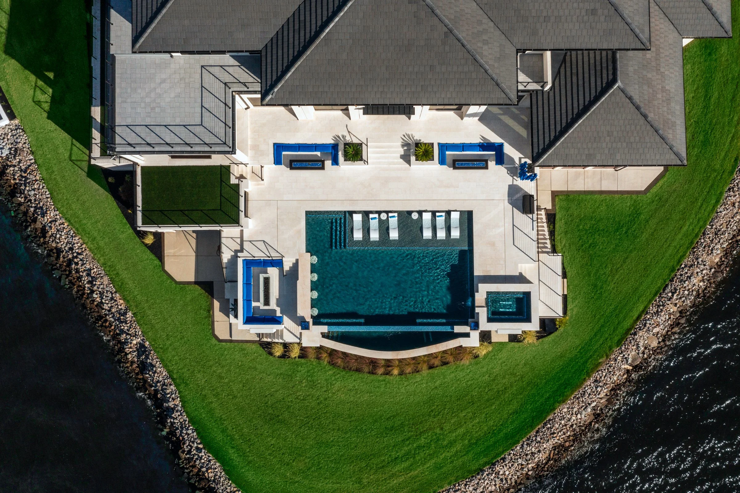 Architectural and interior photography of a customized lakefront home, highlighting design detail, atmosphere, infinity pool, and craftsmanship.