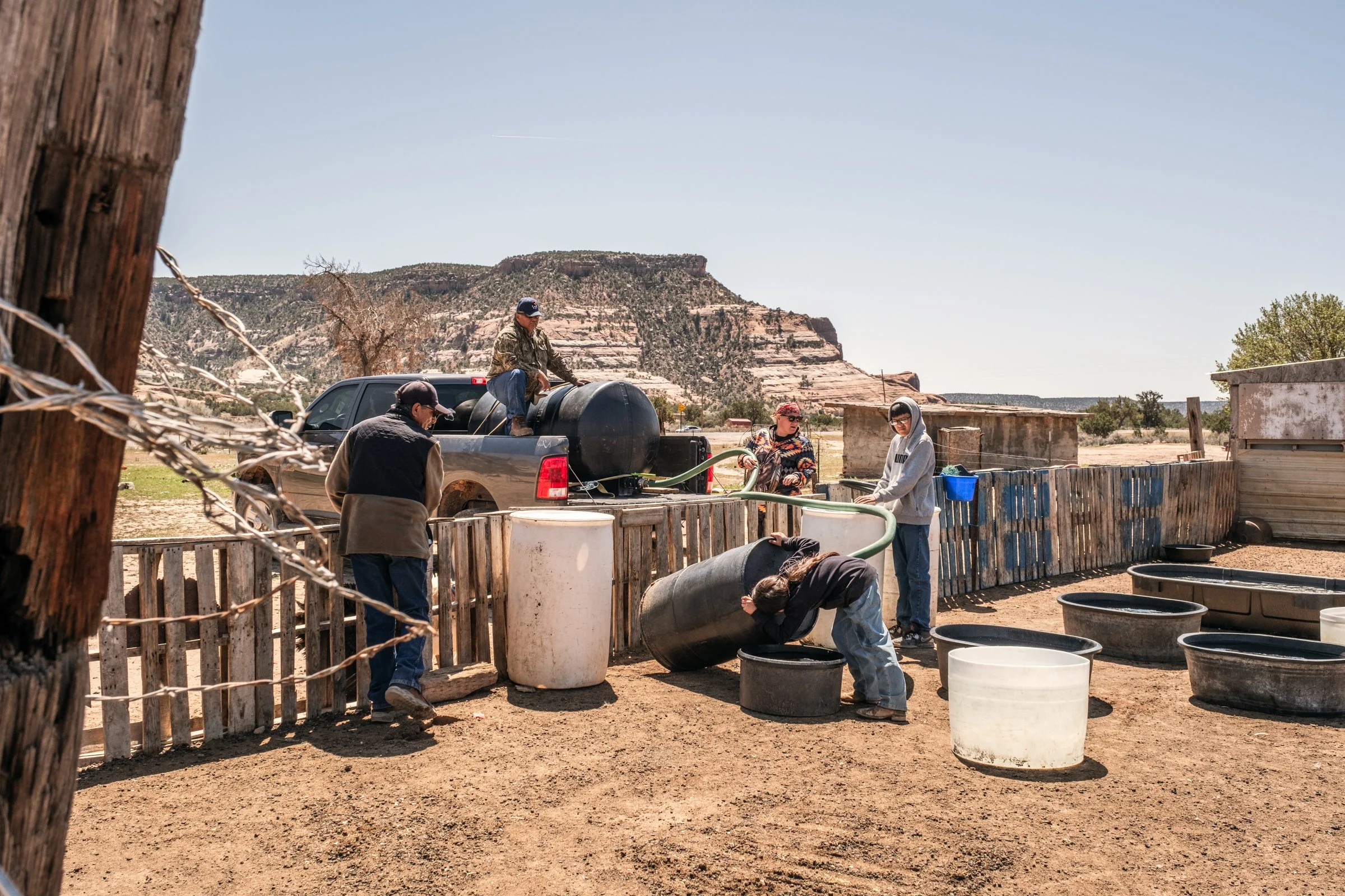 Hauling Life | Navajo Nation — Unified Metadata Paragraphs

Wayne Wilson and Joann Whiting collect water in Gallup, New Mexico at a community water source. The containers are filled, prepared, and loaded into their vehicle for transport across the Na