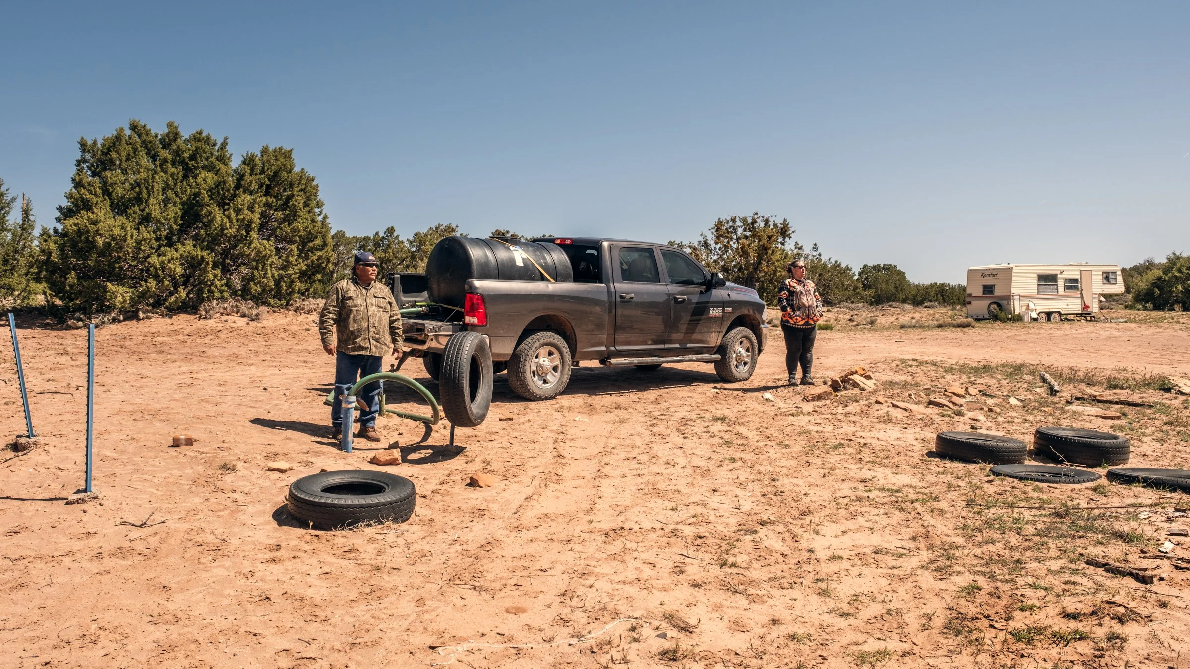 Hauling Life | Navajo Nation — Unified Metadata Paragraphs

Wayne Wilson and Joann Whiting collect water in Gallup, New Mexico at a community water source. The containers are filled, prepared, and loaded into their vehicle for transport across the Na