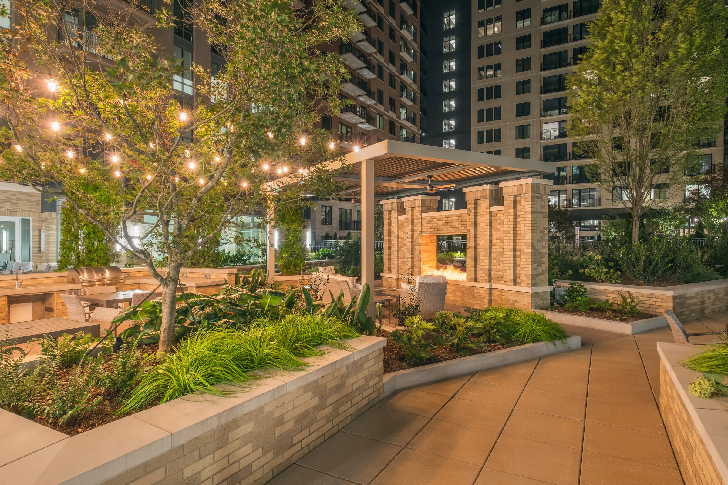 Stunning Courtyard of Village on Morehead featuring modern landscaping, seating areas, and architectural lighting
