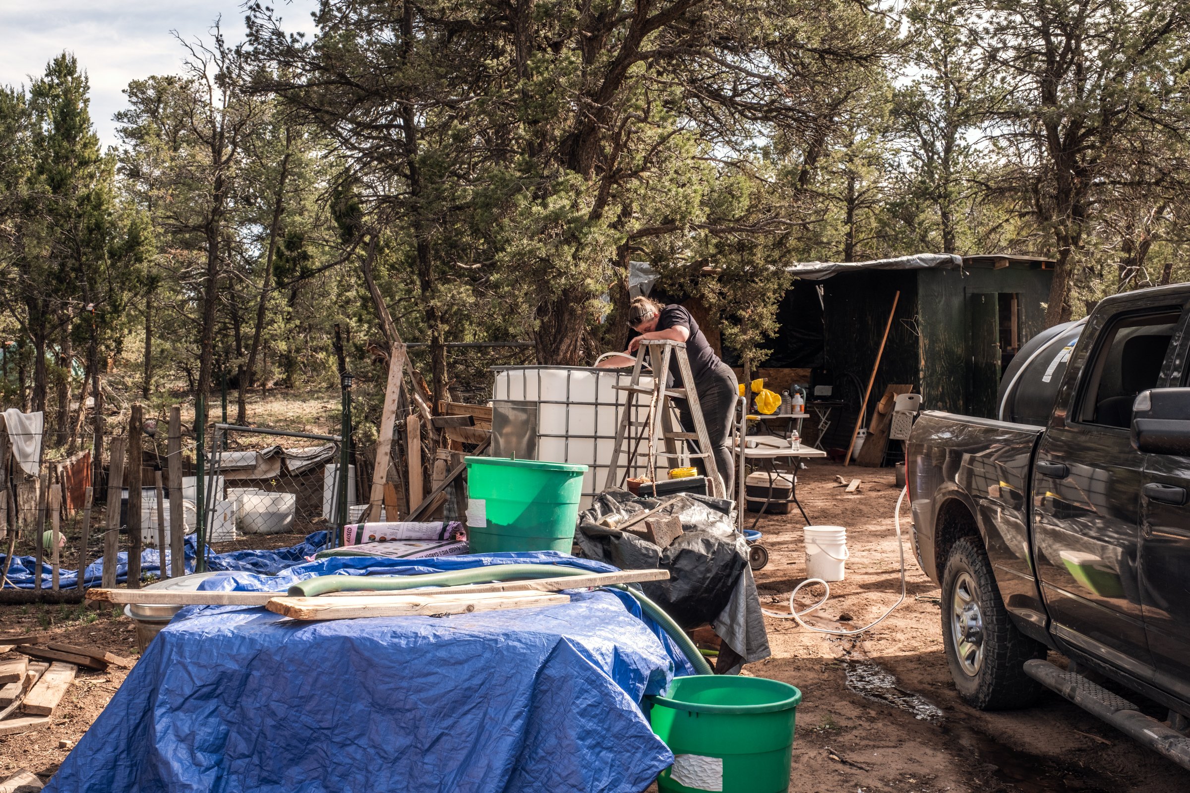 Hauling Life | Navajo Nation — Unified Metadata Paragraphs

Wayne Wilson and Joann Whiting collect water in Gallup, New Mexico at a community water source. The containers are filled, prepared, and loaded into their vehicle for transport across the Na