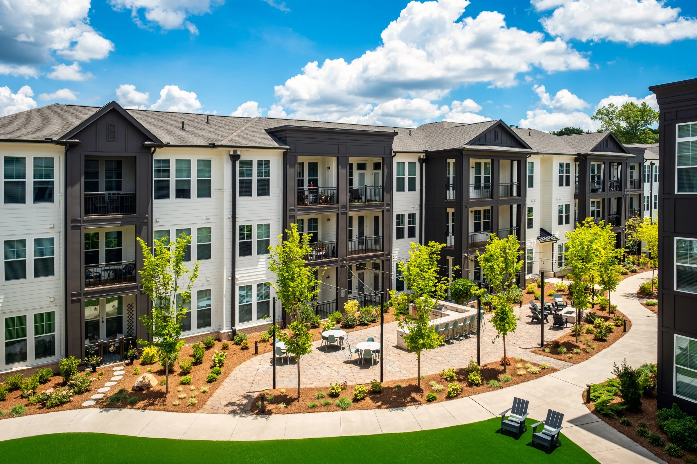 Connery on Providence 55+ community pool and adjacent amenity space, showcasing photography landscape design and seating areas, Charlotte, NC. Created by Lange Photo Studio. 