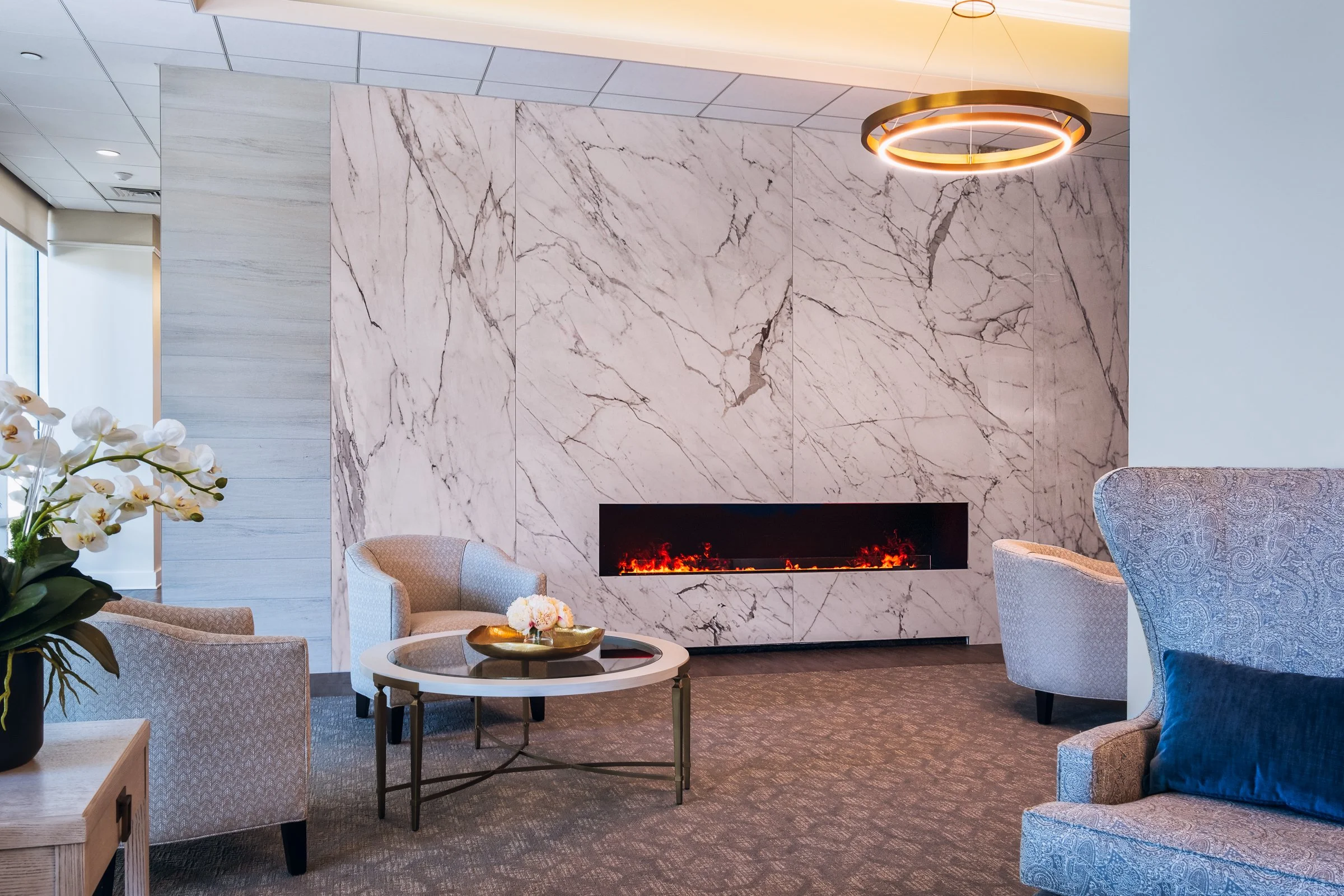 Spacious modern interior lobby of Village on Morehead featuring natural light, contemporary furniture, and architectural details