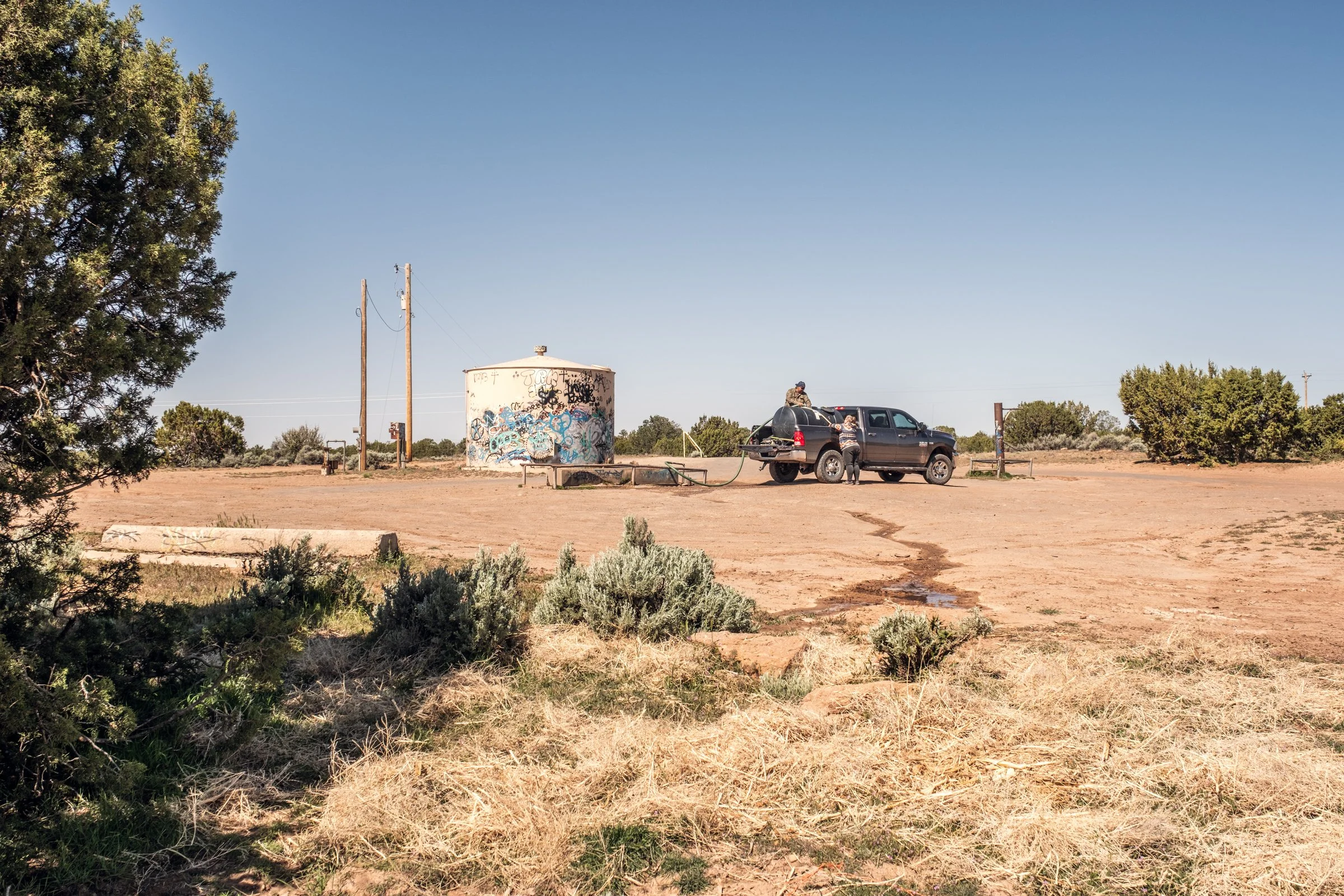 Hauling Life | Navajo Nation — 
Wayne Wilson and Joann Whiting collect water in Gallup, New Mexico at a community water source. The containers are filled, prepared, and loaded into their vehicle for transport across the Navajo Nation.

They depart on