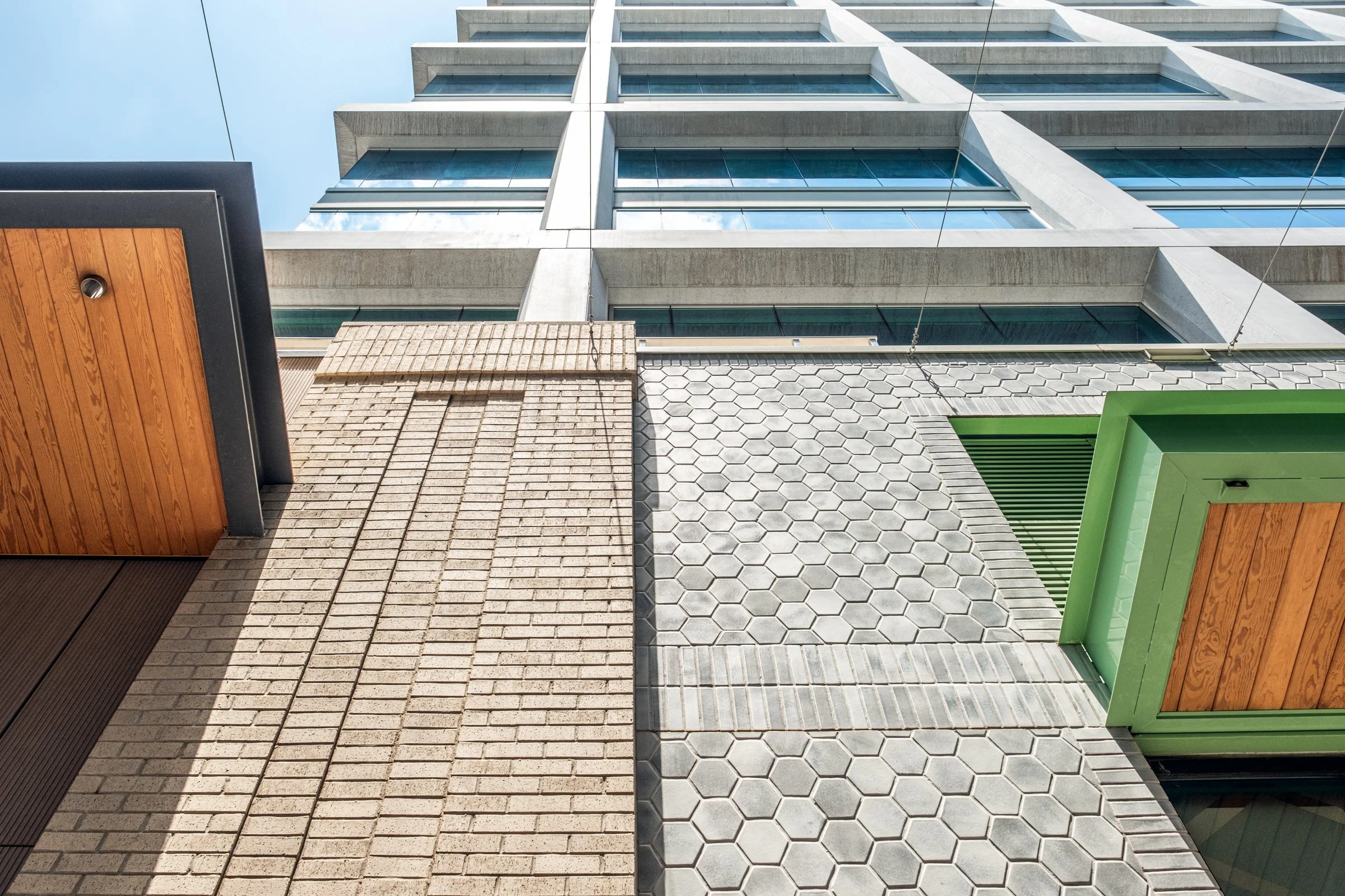 Daytime exterior view of Ally Charlotte Center, highlighting its modern architecture and urban setting in Uptown Charlotte.”