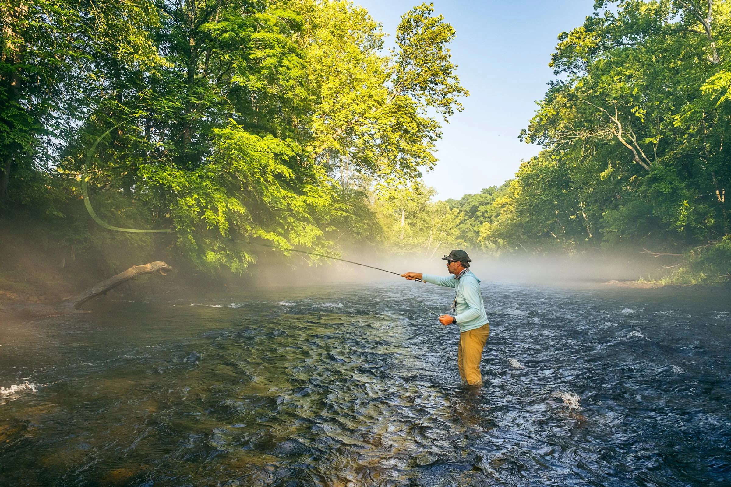 Guided fly fishing trip with Asheville Fly Fishing Company on a foggy river near Asheville, North Carolina. Photographed by Lange Photo Studio.