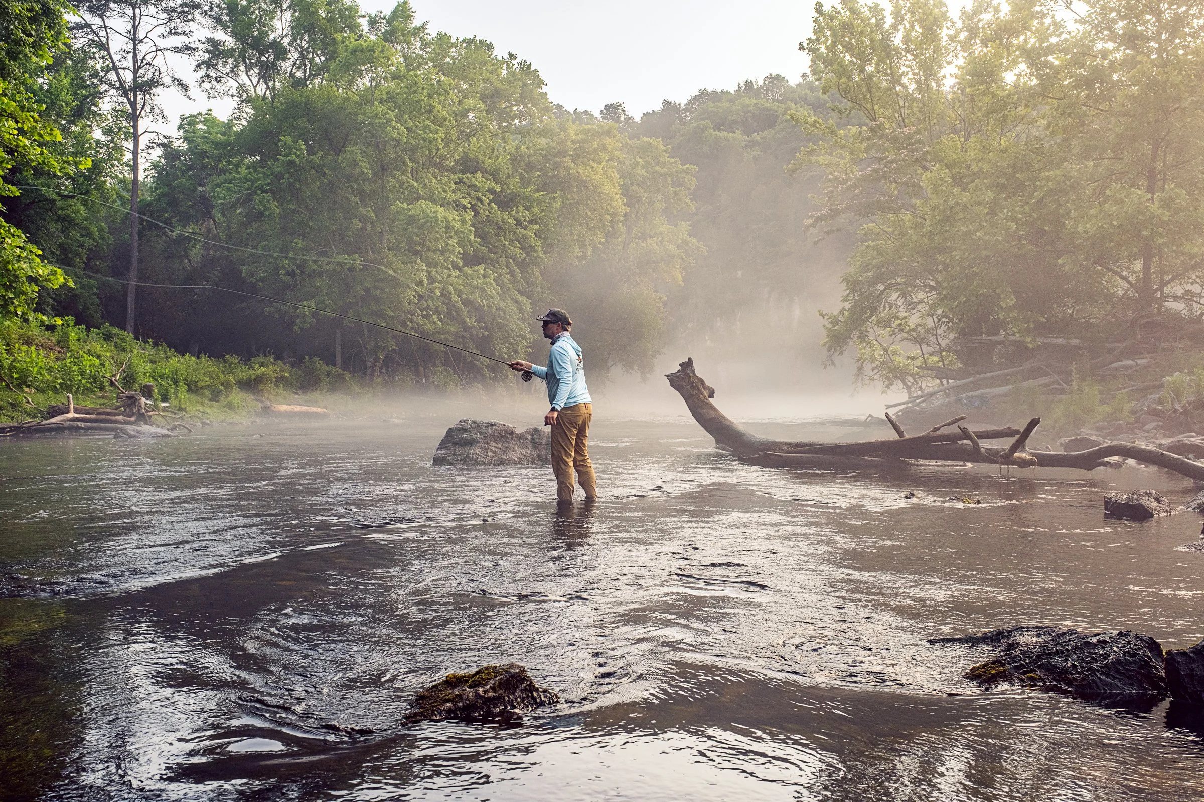 Guided fly fishing trip with Asheville Fly Fishing Company on a foggy river near Asheville, North Carolina. Photographed by Lange Photo Studio.