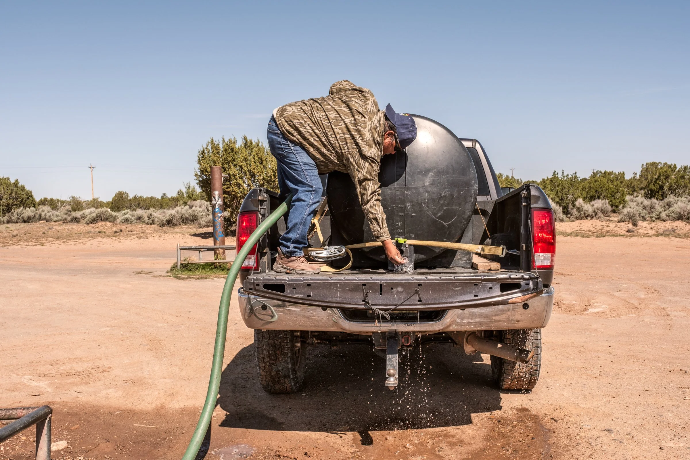 Hauling Life | Navajo Nation — Unified Metadata Paragraphs

Wayne Wilson and Joann Whiting collect water in Gallup, New Mexico at a community water source. The containers are filled, prepared, and loaded into their vehicle for transport across the Na