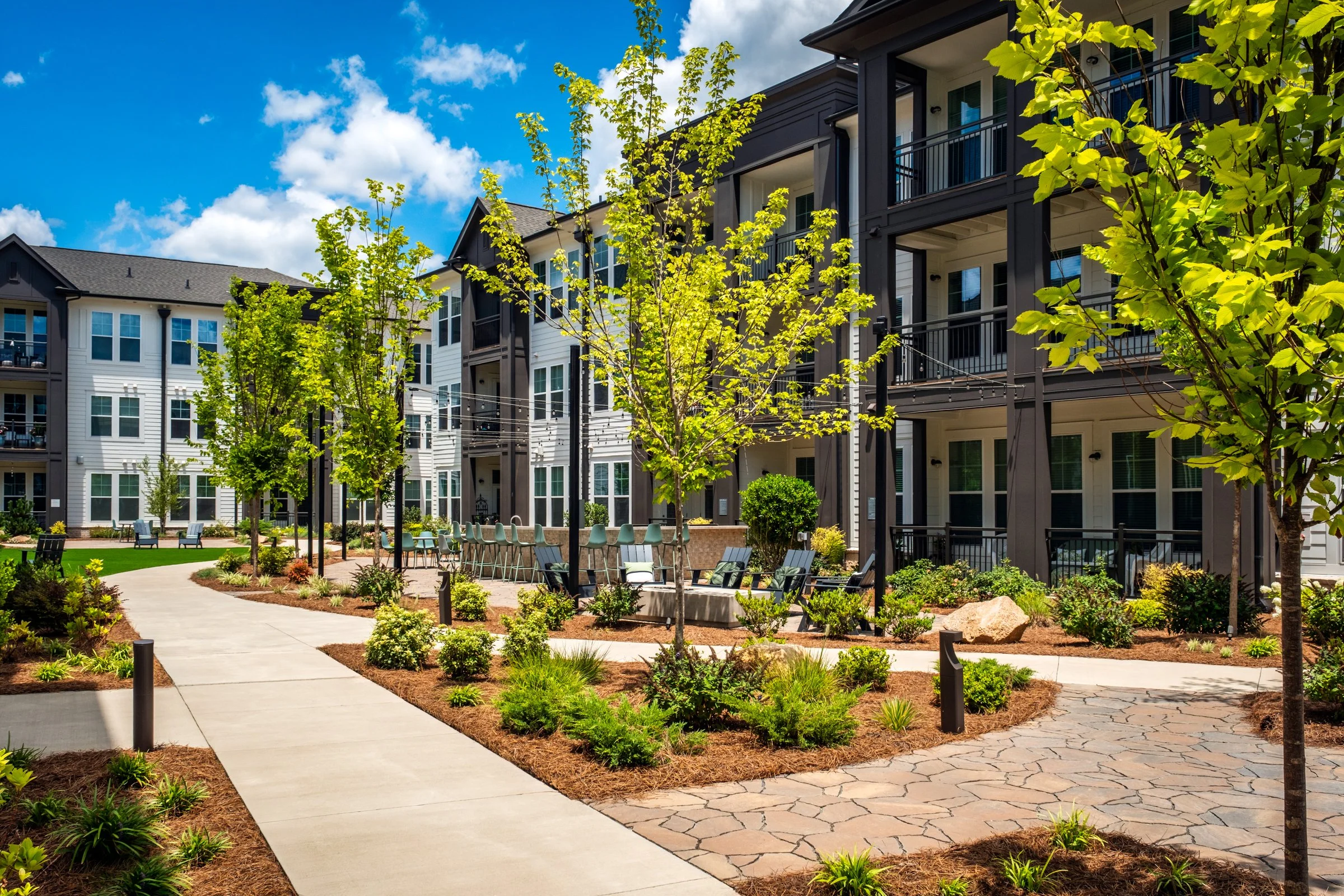 Connery on Providence 55+ community pool and adjacent amenity space, showcasing photography landscape design and seating areas, Charlotte, NC. Created by Lange Photo Studio. 
