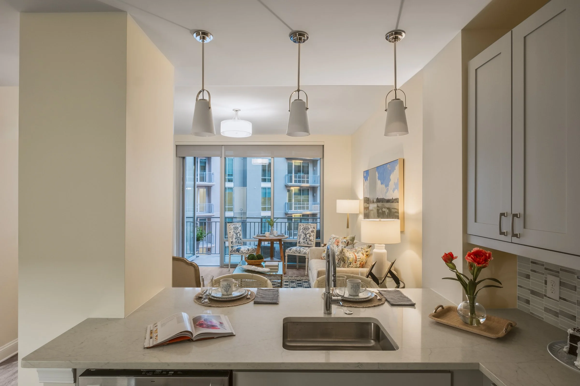 Open concept dining and entertainment space in Village on Morehead unit highlighting contemporary design elements