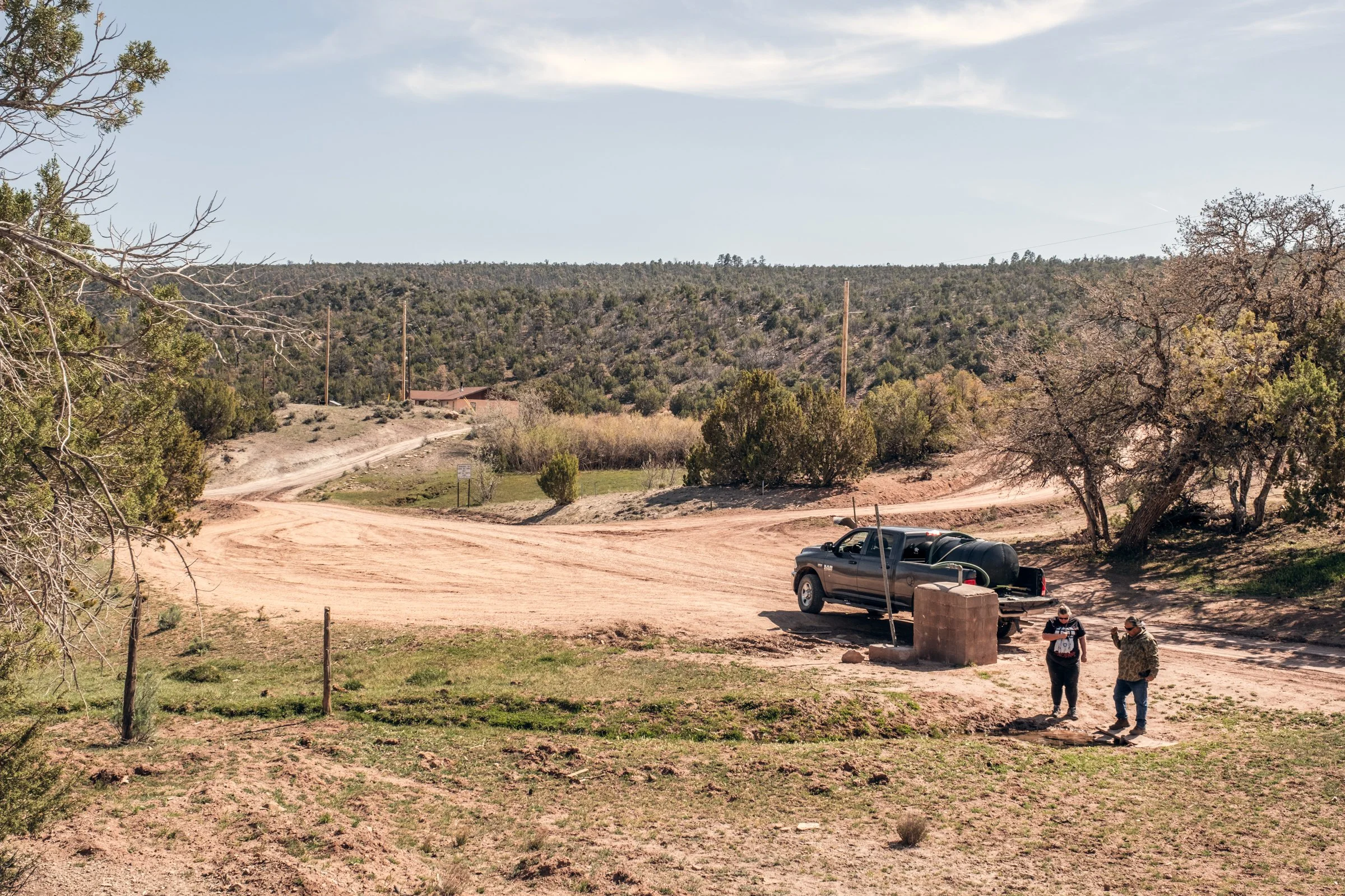 Hauling Life | Navajo Nation — Unified Metadata Paragraphs

Wayne Wilson and Joann Whiting collect water in Gallup, New Mexico at a community water source. The containers are filled, prepared, and loaded into their vehicle for transport across the Na