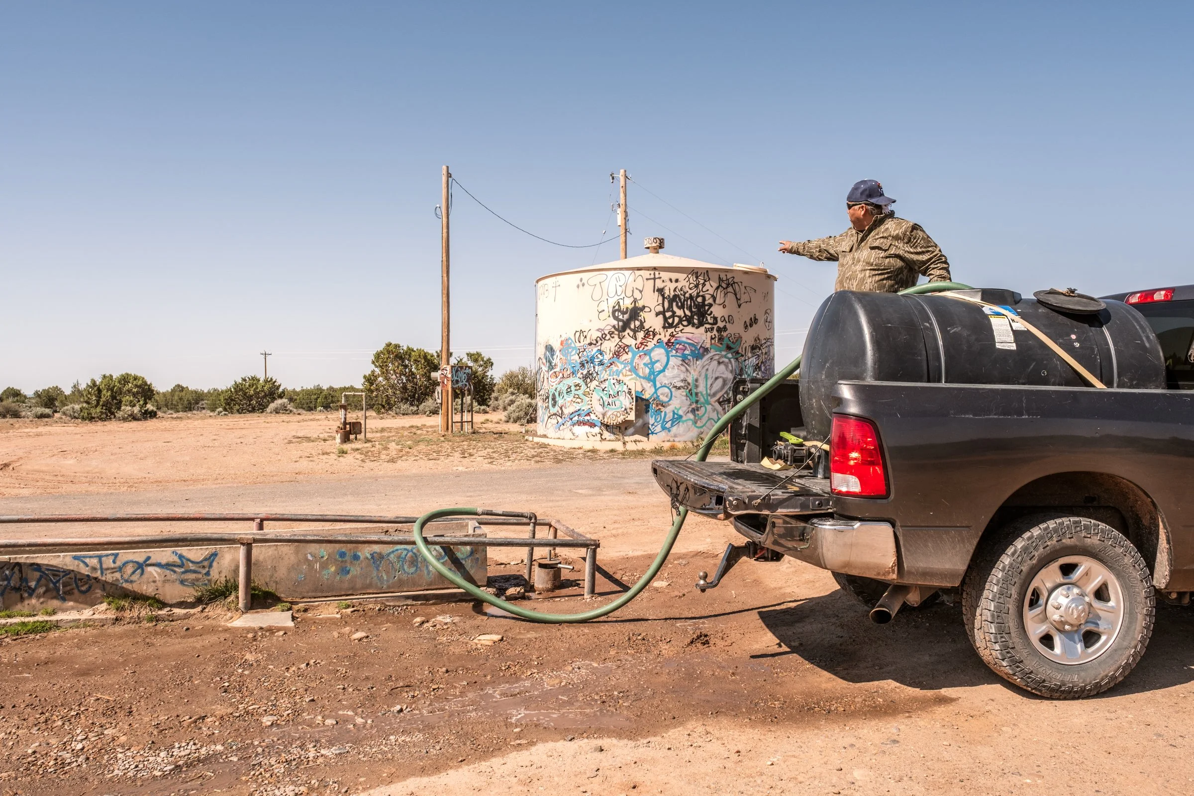 Hauling Life | Navajo Nation — Unified Metadata Paragraphs

Wayne Wilson and Joann Whiting collect water in Gallup, New Mexico at a community water source. The containers are filled, prepared, and loaded into their vehicle for transport across the Na