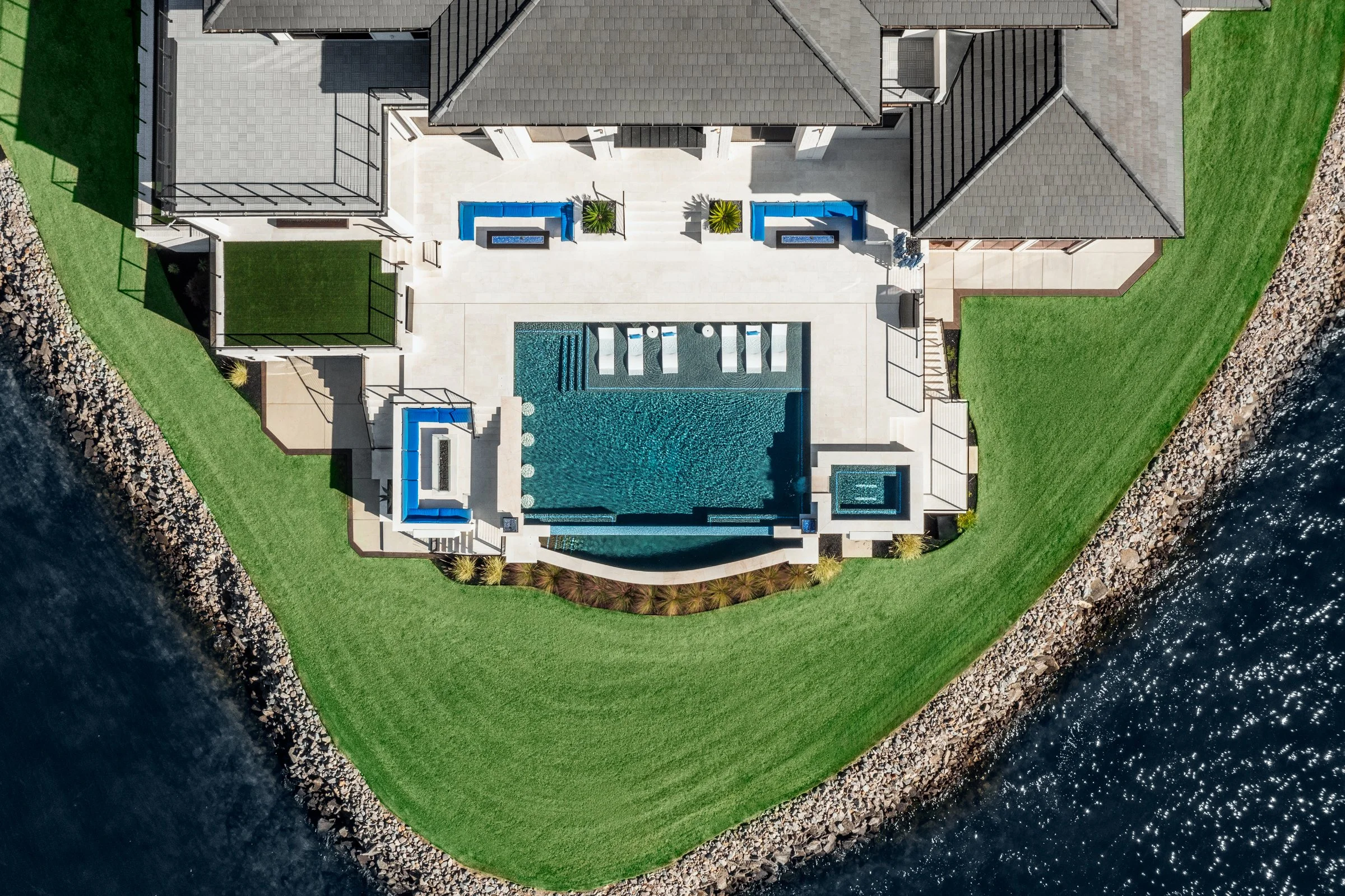 Architectural and interior photography of a customized lakefront home, highlighting design detail, atmosphere, infinity pool, and craftsmanship.