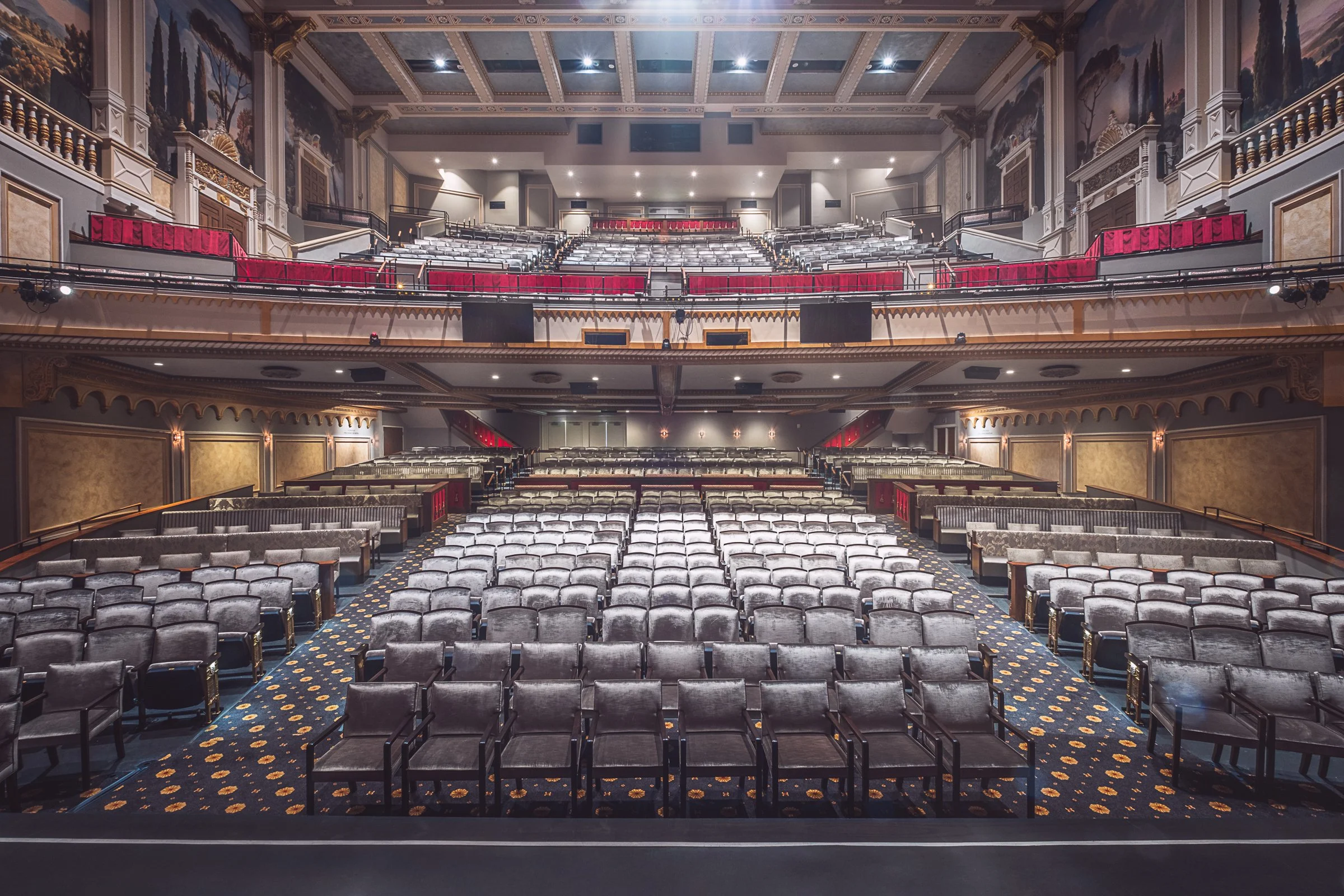 Wide view of Carolina Theatre auditorium and stage in Charlotte, showcasing restored seating, lighting, and historic architecture.”