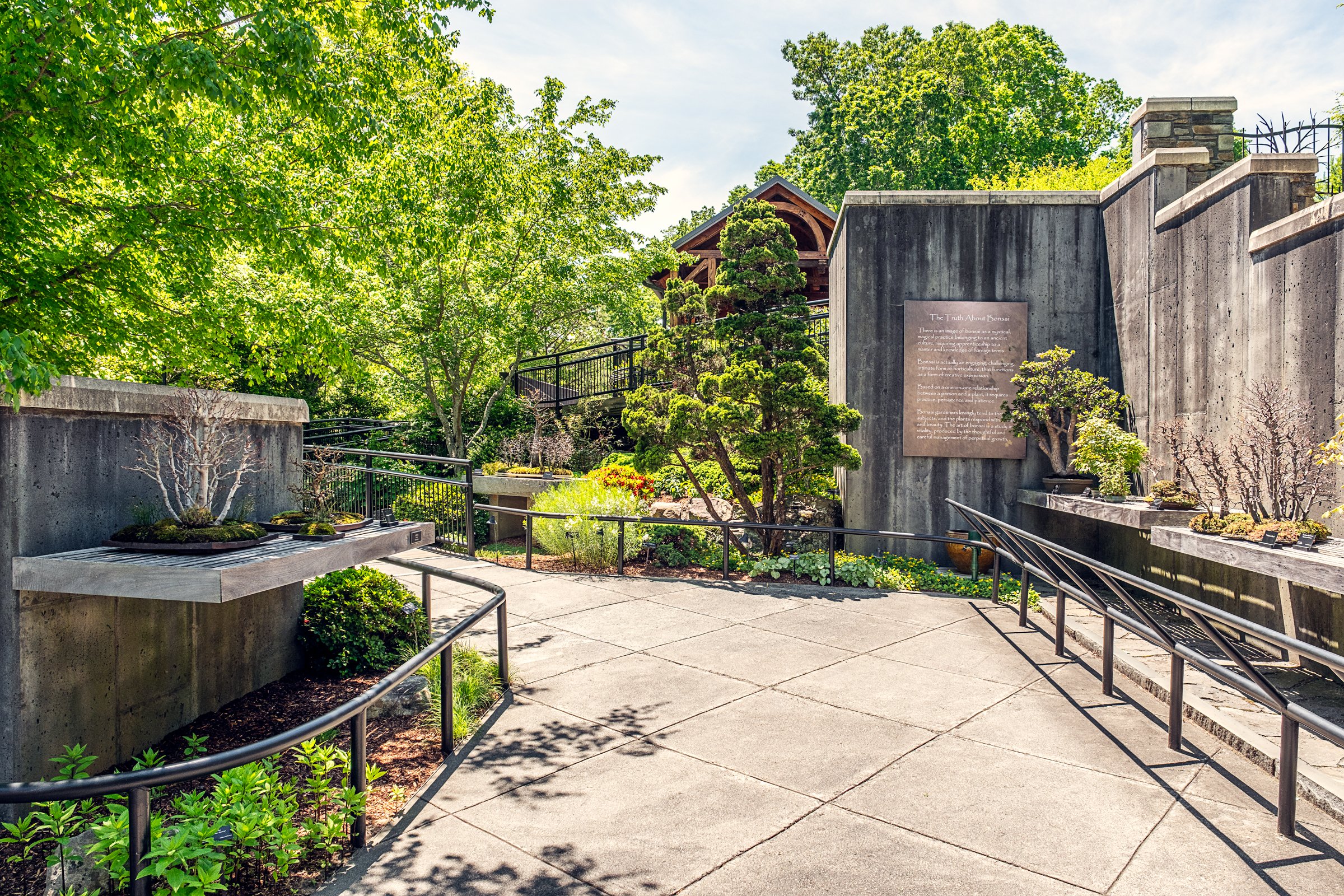 A quiet garden path and bonsai display at the North Carolina Arboretum near Asheville, North Carolina. Photographed by Lange Photo Studio. 