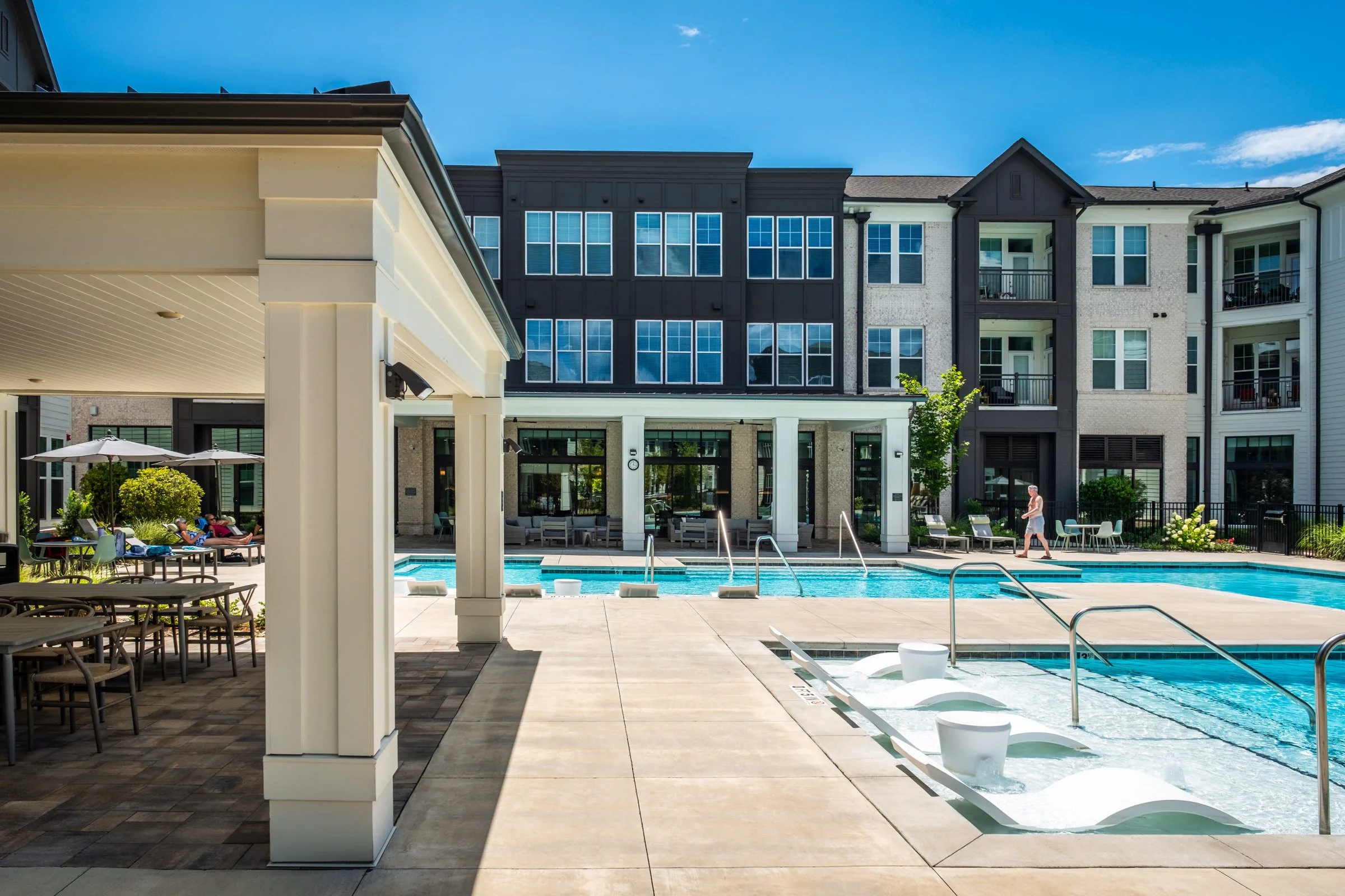 Connery on Providence 55+ community pool and adjacent amenity space, showcasing photography landscape design and seating areas, Charlotte, NC. Created by Lange Photo Studio. 