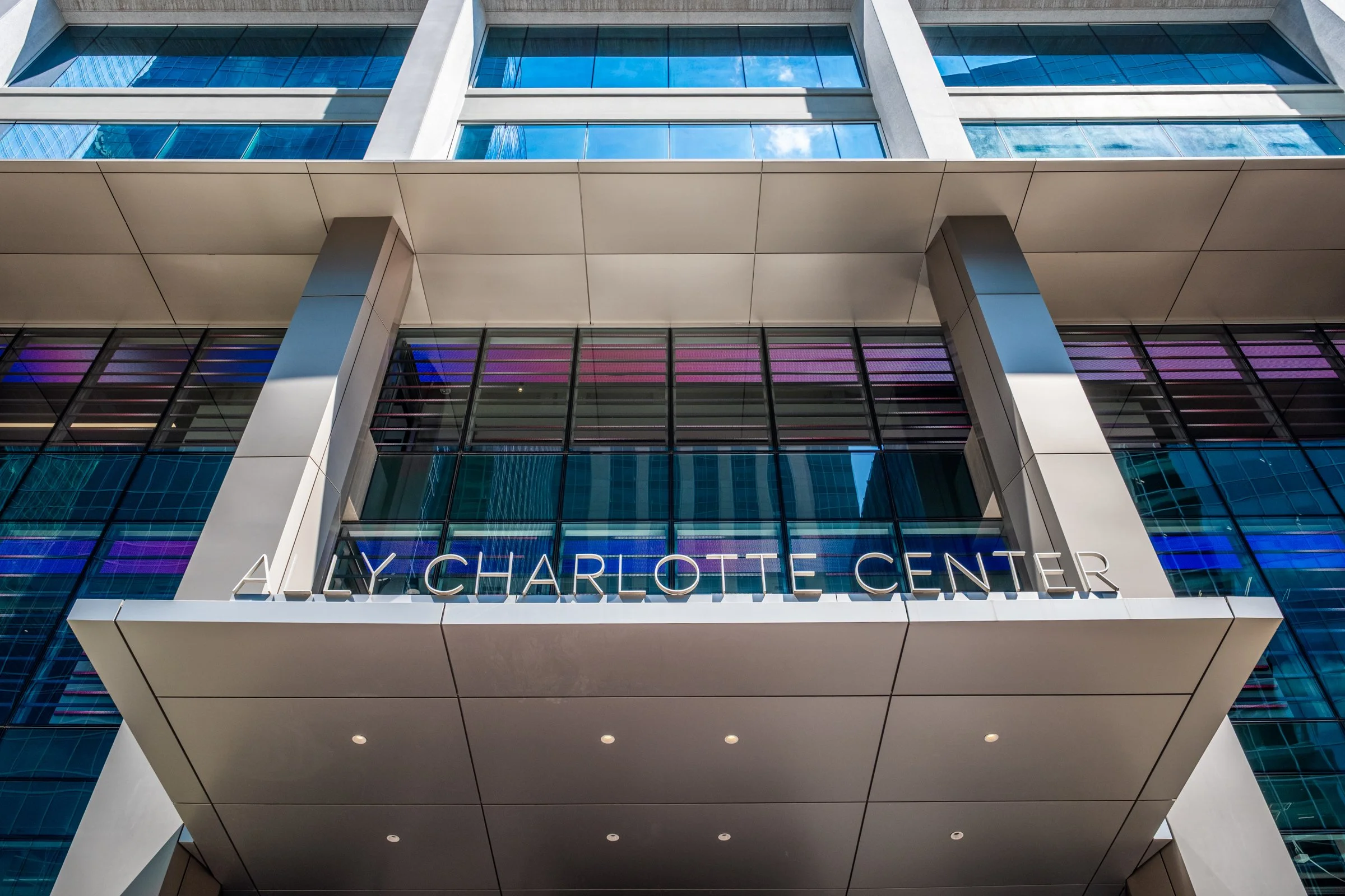 Daytime exterior view of Ally Charlotte Center, highlighting its modern architecture and urban setting in Uptown Charlotte.”