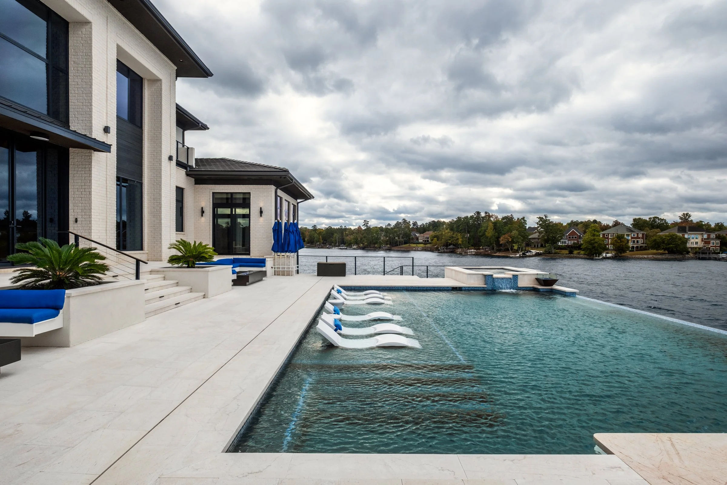 Architectural and interior photography of a customized lakefront home, highlighting design detail, atmosphere, infinity pool, and craftsmanship.