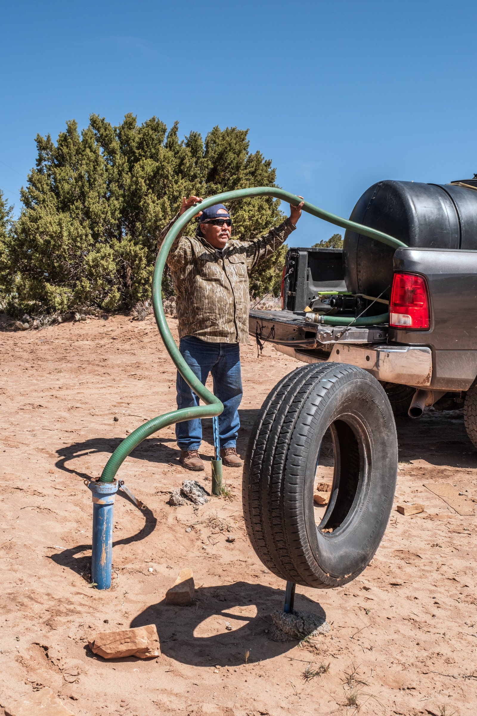 Hauling Life | Navajo Nation — Unified Metadata Paragraphs

Wayne Wilson and Joann Whiting collect water in Gallup, New Mexico at a community water source. The containers are filled, prepared, and loaded into their vehicle for transport across the Na