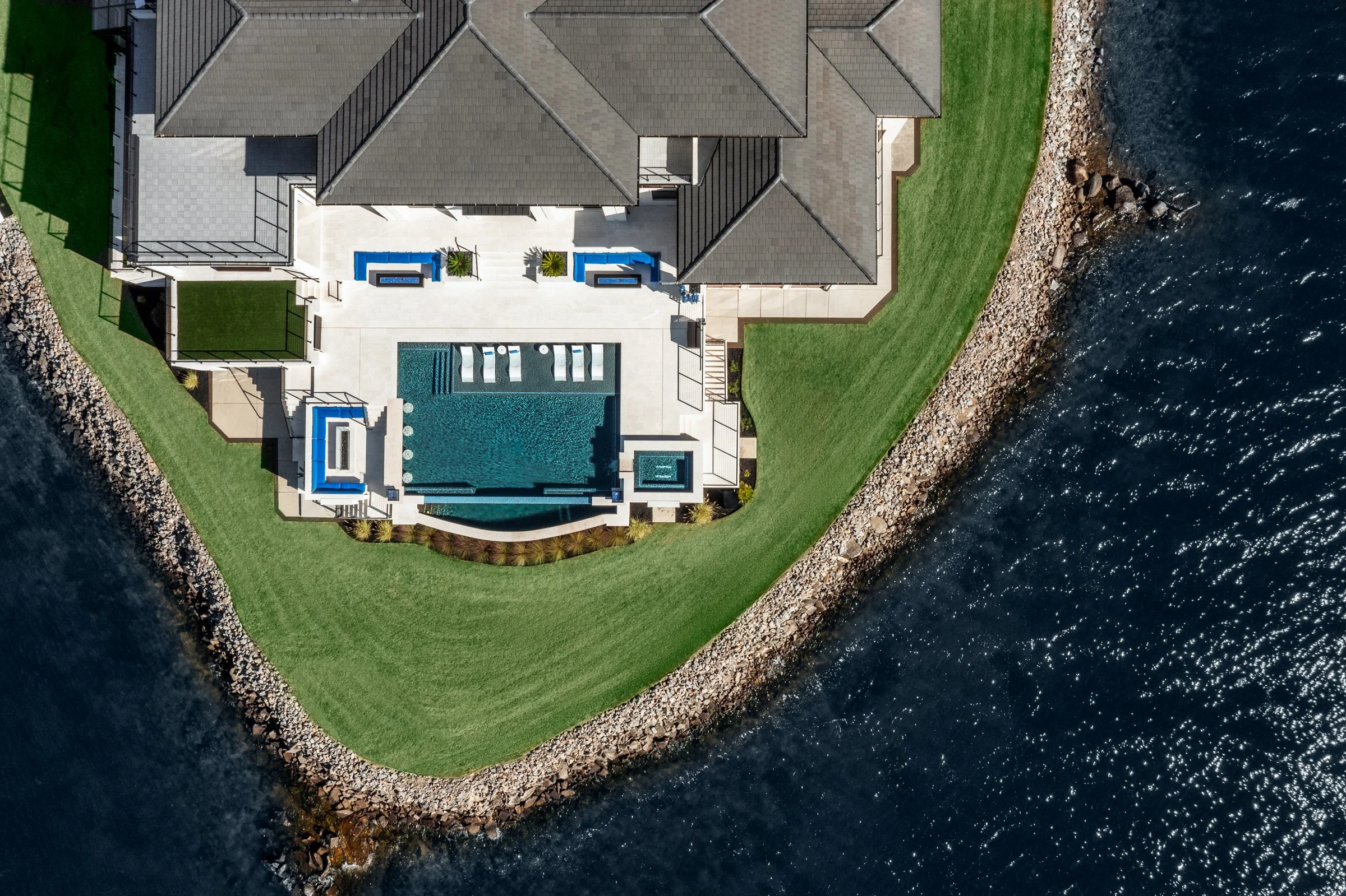 Architectural and interior photography of a customized lakefront home, highlighting design detail, atmosphere, infinity pool, and craftsmanship.