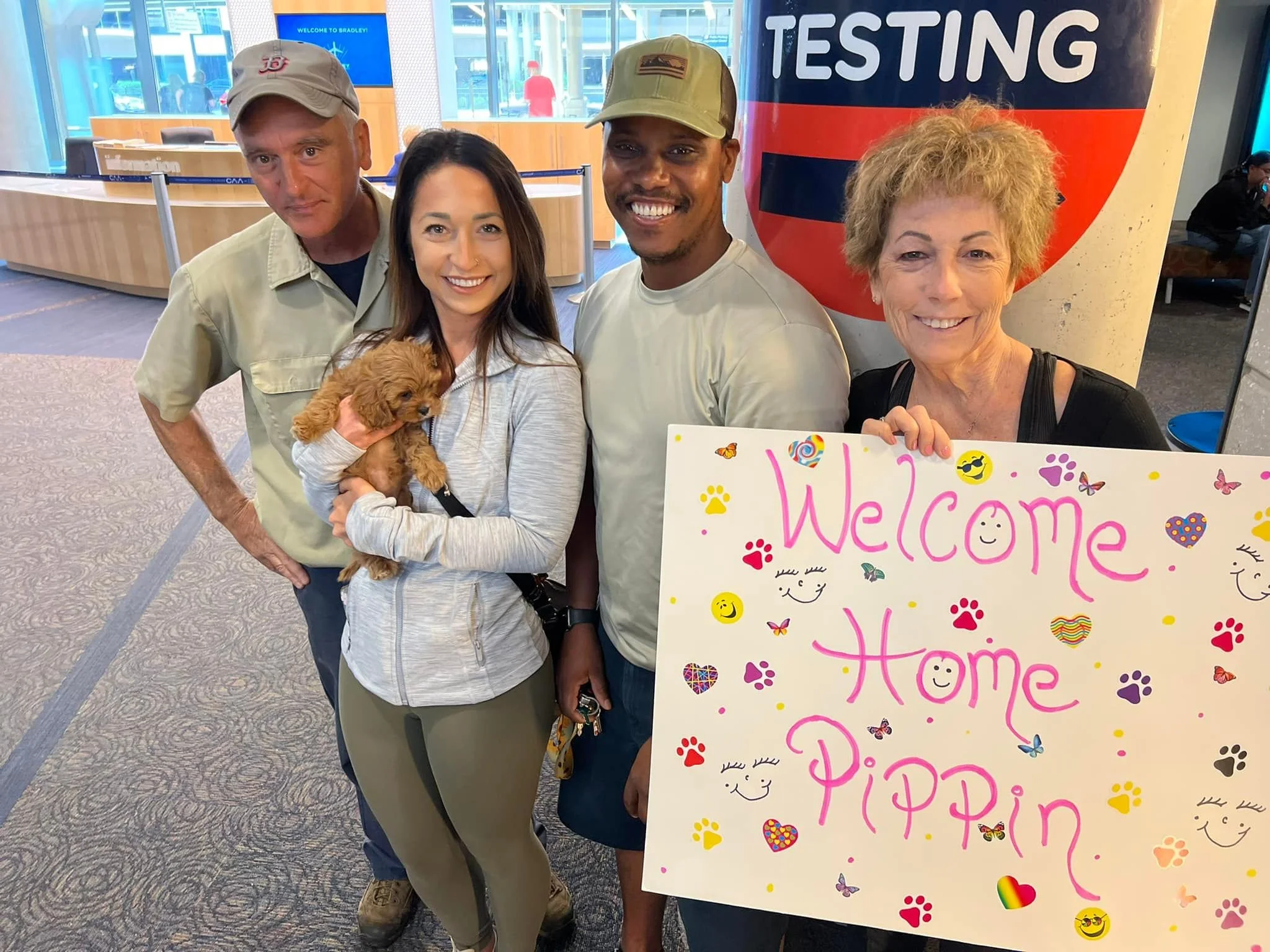 welcome home new pet dog with family holding welcome sign