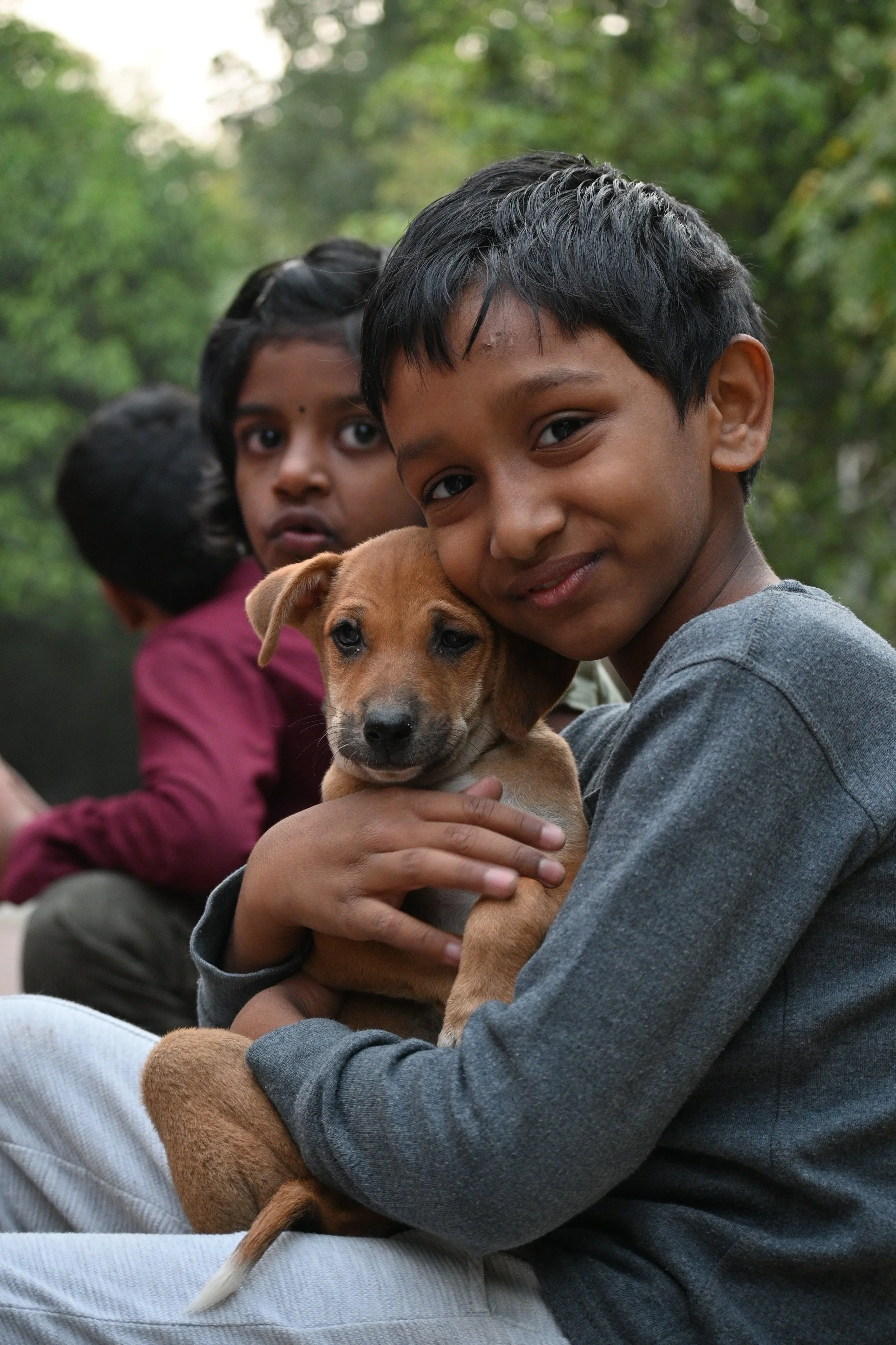 smiling children with their new pet puppy