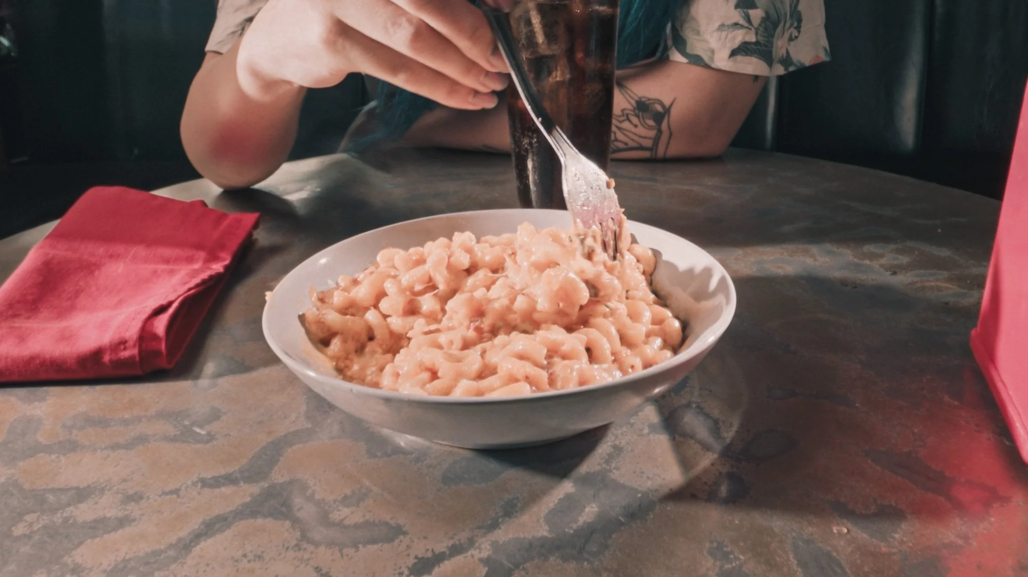 An Autistic person eating a plain bowl of pasta