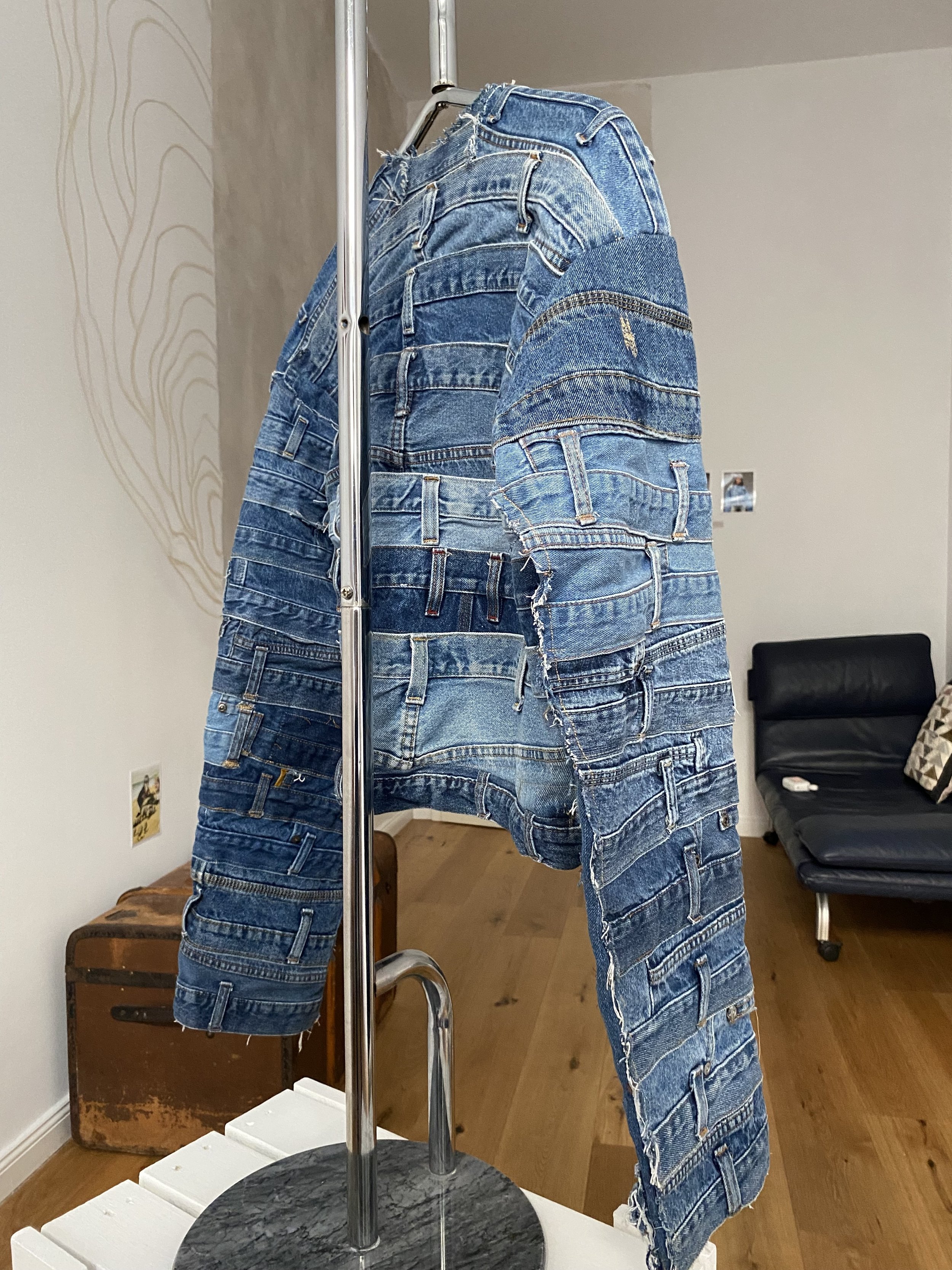 denim jacket hanging slight angle from behind.jpg