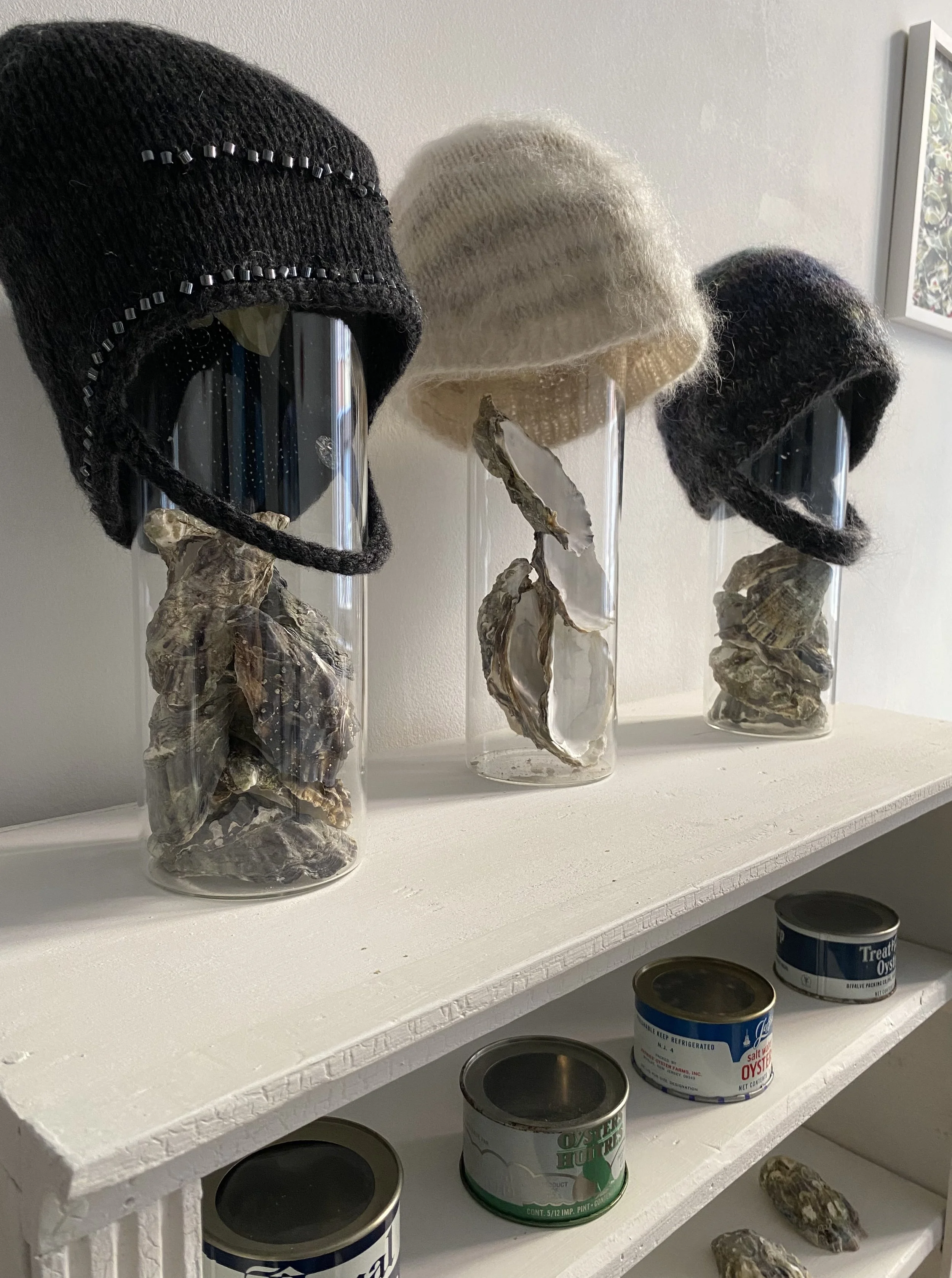 Three Bonnets on stands in a row left angle.jpg