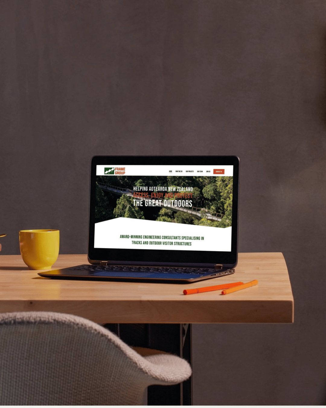 Frame Group website on laptop