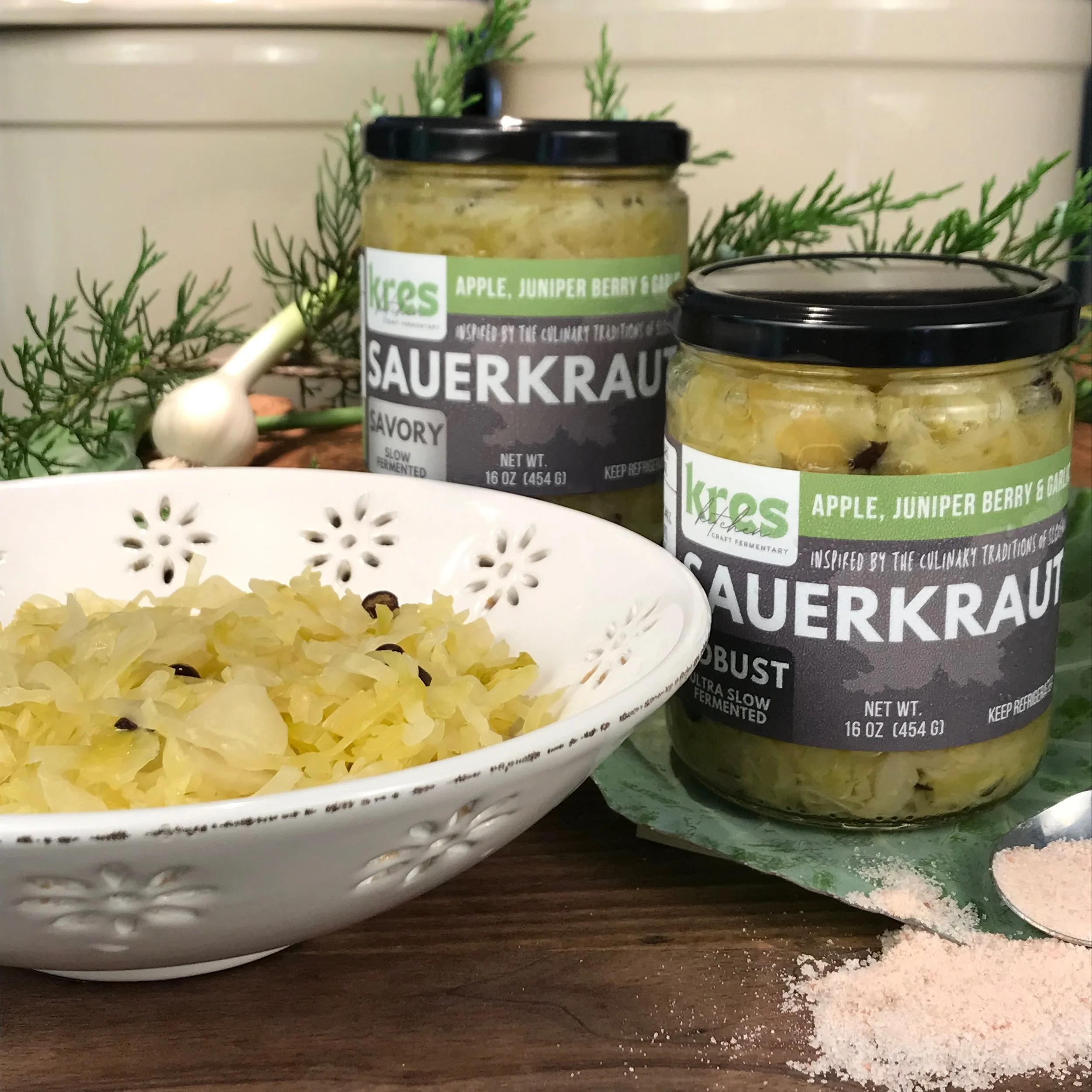 Kres Kitchen Apple Juniper Berry and Garlic Sauerkraut in jars and in a ready to eat bowl