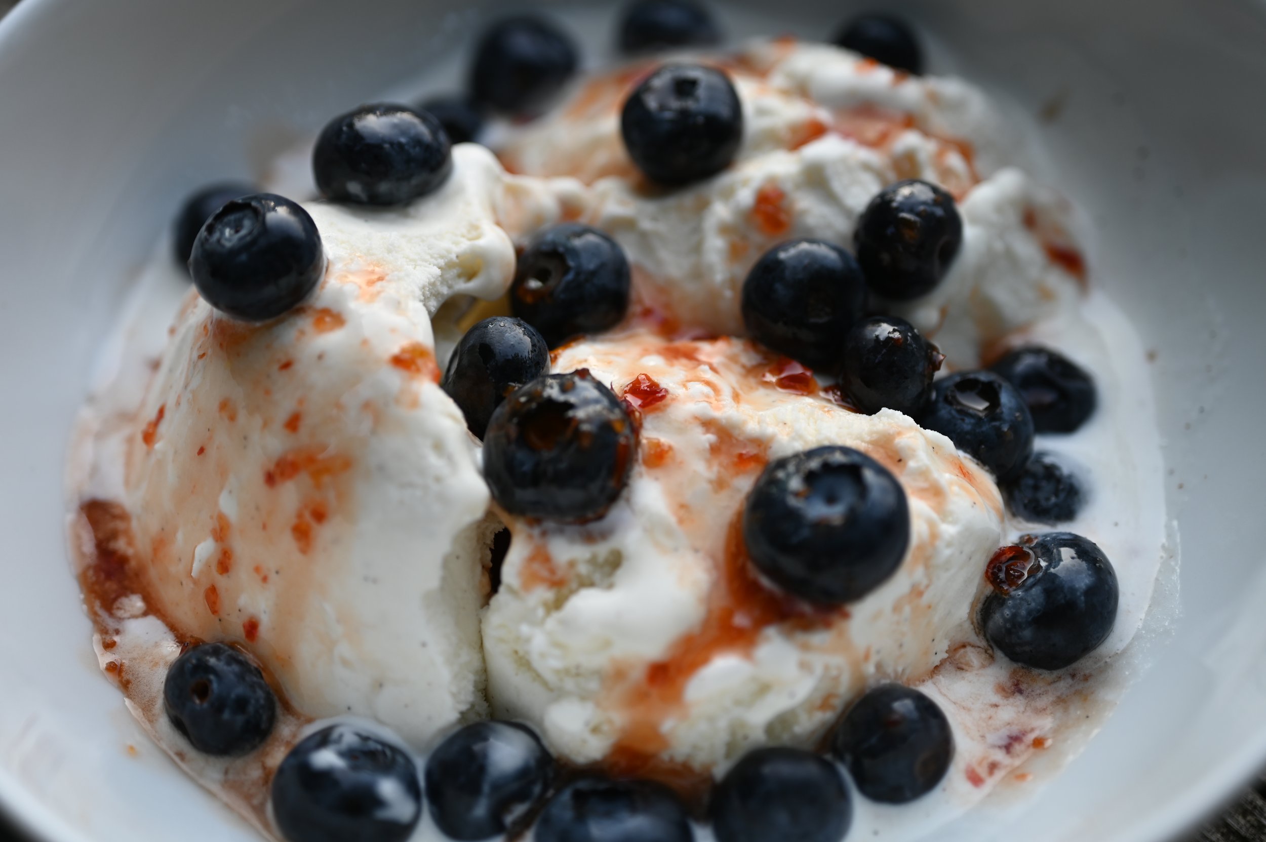 Vanilla ice cream with fresh blueberries and drizzled with swicy sauce made with Kres Kitchen Wildfire Hot Pepper Paste