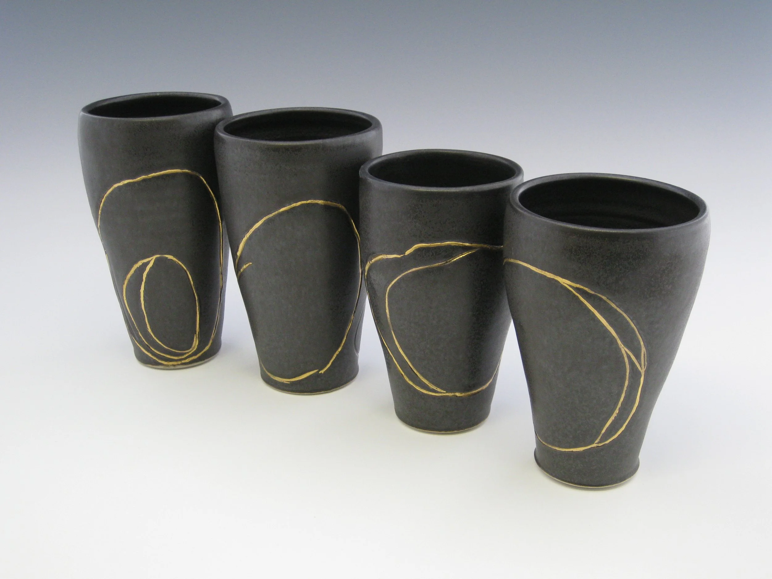 Black Glazed Wheel thrown poreclain cups w_ gold Lustre, 2008.JPG