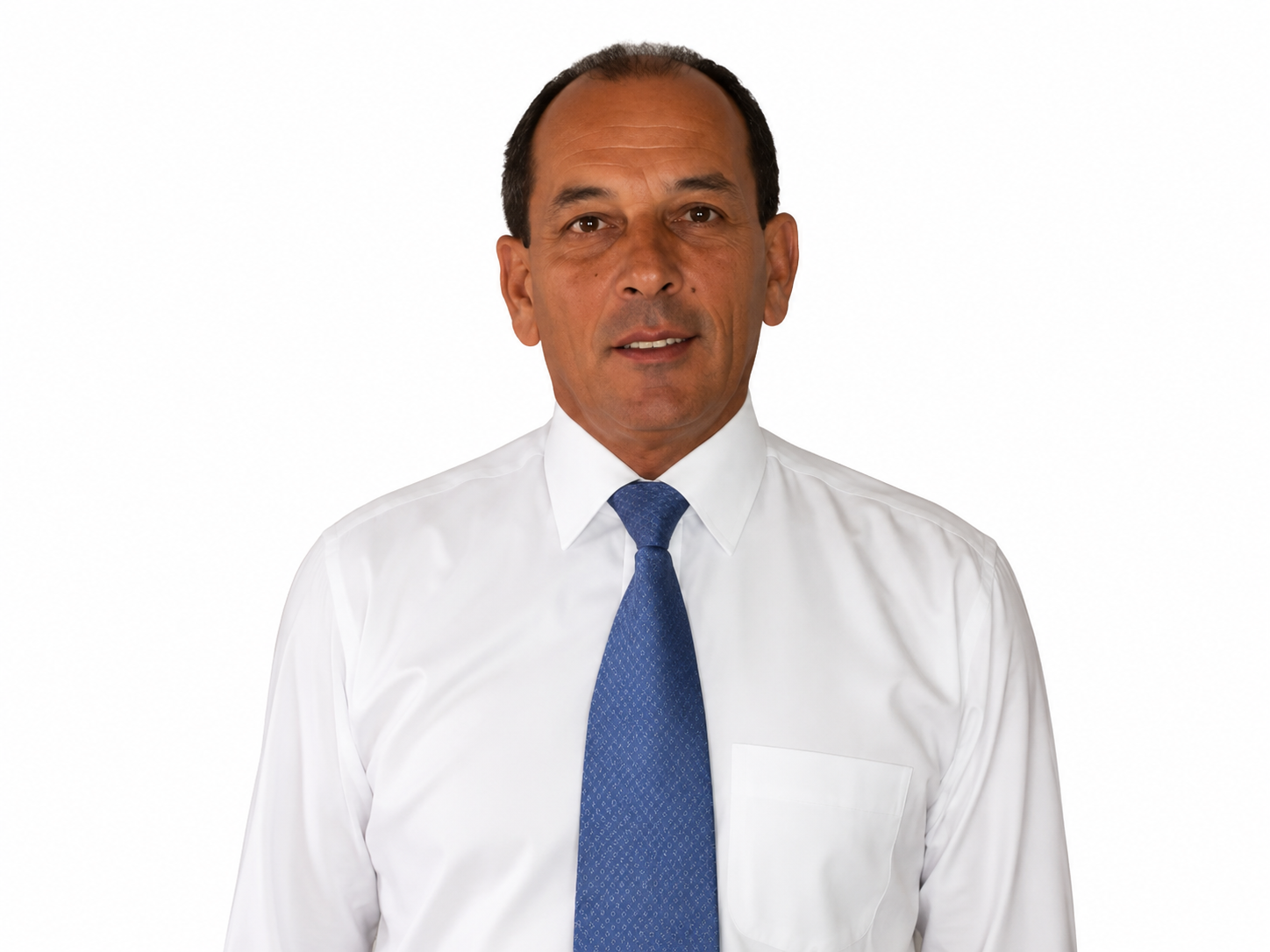 Man in white shirt and blue tie standing against a plain background.