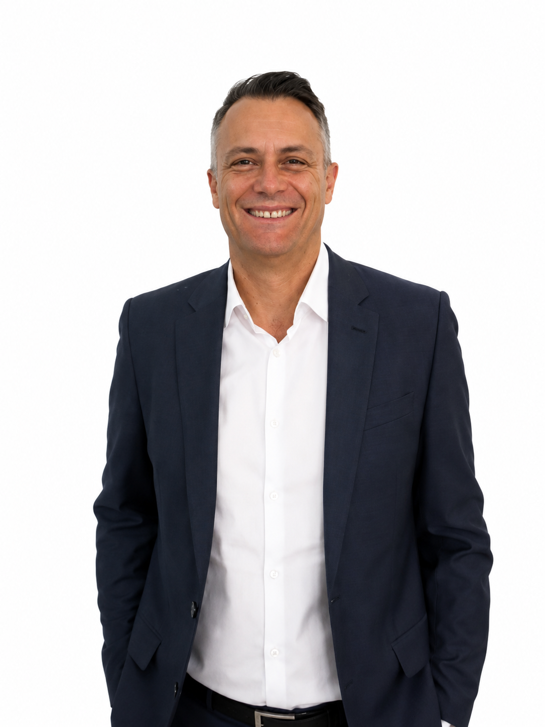 Man in a suit smiling against a plain background