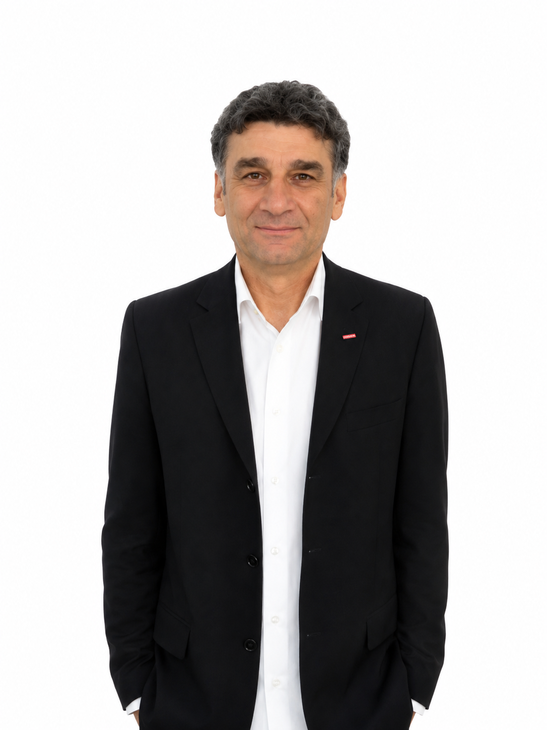 Man in a suit standing against a white background.