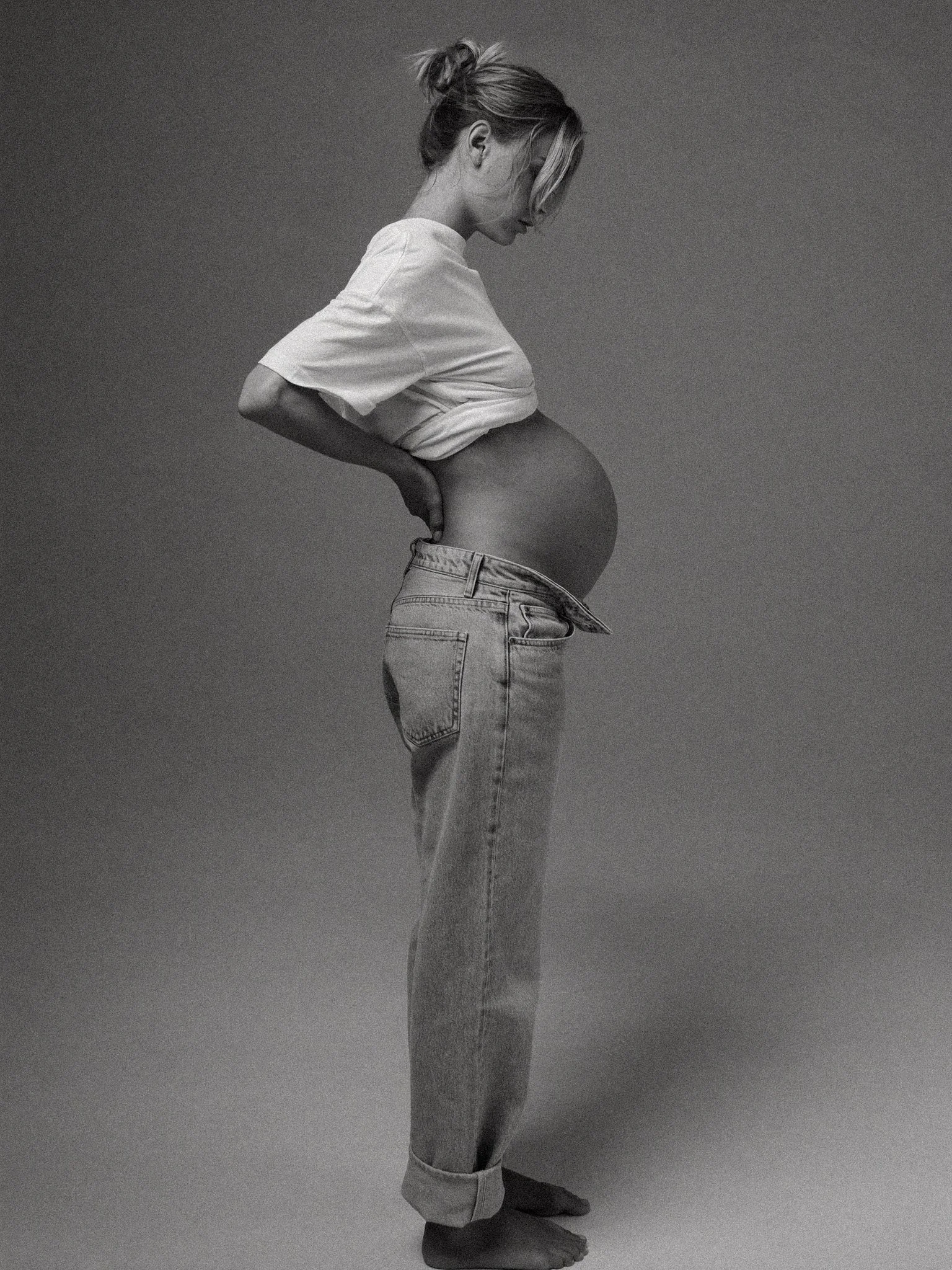 Mothers Day - Pregnant woman in white tee and denim jeans portrait - TVS.jpg