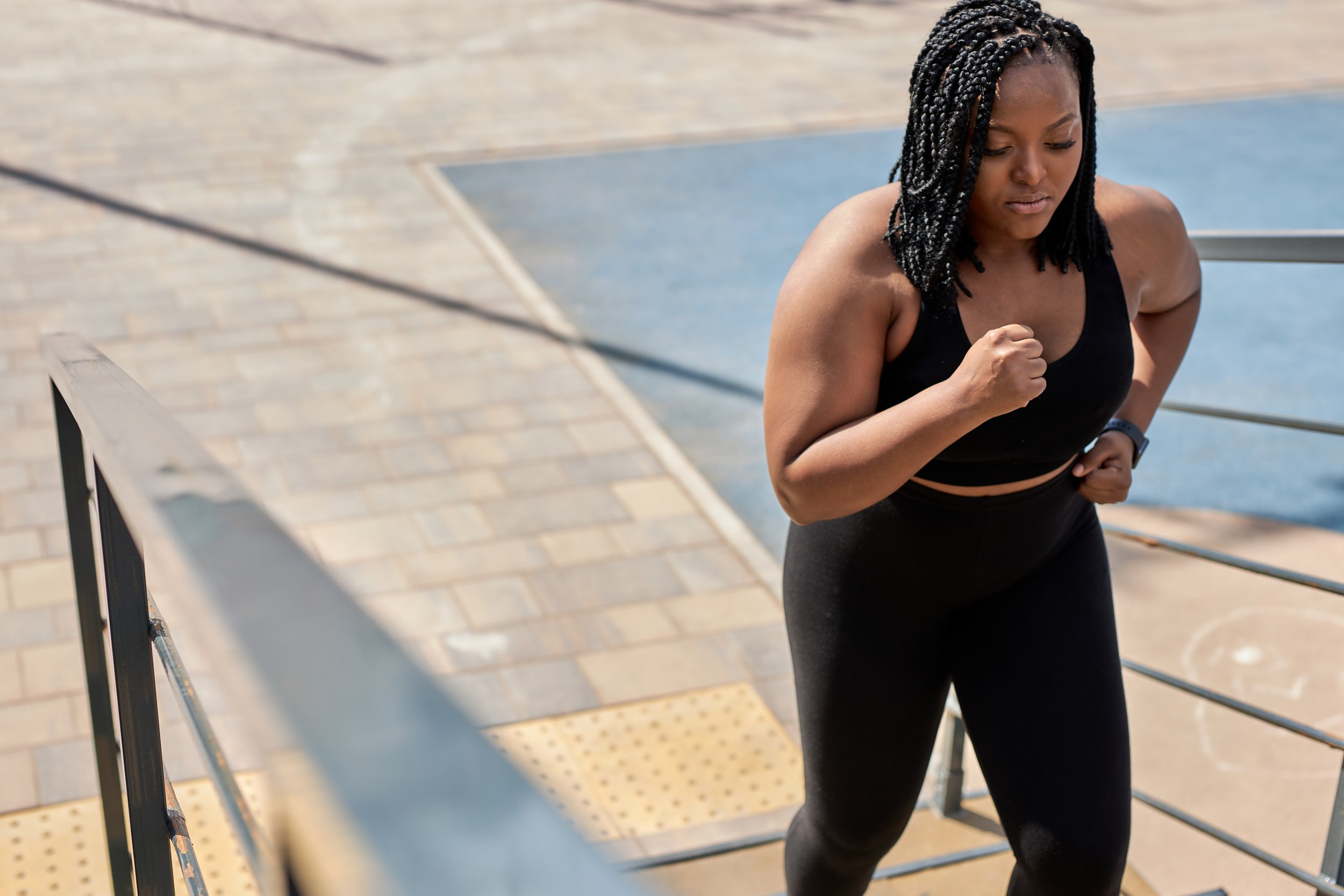 Black woman running up the steps