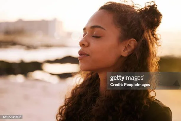 Black woman taking a deep breath